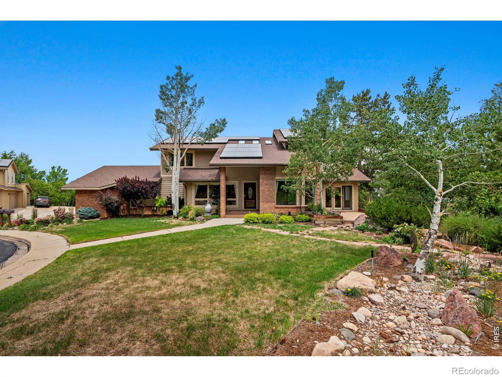 Nestled at the base of the iconic Flatirons and perfectly centered in a quiet cul-de-sac, this stunning South Boulder home is as close to perfection as Colorado living gets. With sweeping city views, an unbeatable location, and thoughtful finishes throughout, this is the one you've been waiting for. The main floor welcomes you with rich hardwood floors, a large formal dining room, and a sun-filled breakfast nook - ideal for quiet mornings or lively gatherings alike. The chef's kitchen features granite countertops, stainless steel appliances, and a 5-burner gas range, while the spacious family room flows seamlessly to multiple decks and a spectacular flagstone patio below - an entertainer's dream all four seasons. Upstairs, the primary suite is a true retreat, complete with a luxurious 5-piece en-suite bath and a custom built-in closet. Two additional bedrooms each feature charming loft spaces - perfect for kids, reading nooks, or creative corners. A dedicated home office rounds out the upper level, offering the quiet and separation today's lifestyle demands. The walk-out basement expands your living space with a generous recreation area, a 3/4 bath, and a proper wine cellar for the collector in you. Outside, the community amenities impress - enjoy access to a pool and multiple tennis courts just steps from your door.. This is South Boulder at its finest: trail access, mountain views, and a home that truly has it all.