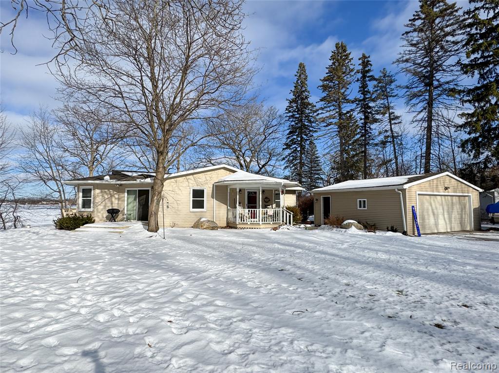 Lakefront Living, offering 100 feet of direct frontage on all-sports Loon Lake. Situated as the last home on a quiet dead-end street, this property provides added privacy and minimal traffic. This 2,016 sq ft home features beautiful water views from the main living areas and an open-concept layout filled with natural light. The inviting living room showcases a brick fireplace with custom built-ins, while the kitchen offers granite countertops, stainless steel appliances, and ample cabinetry. Hardwood floors add warmth throughout much of the home. Updated bathrooms include granite vanities and a tiled walk-in shower. Enjoy the spacious lakeside deck and easy shoreline access for boating, swimming, and year-round lake living. Detached garage for additional storage.