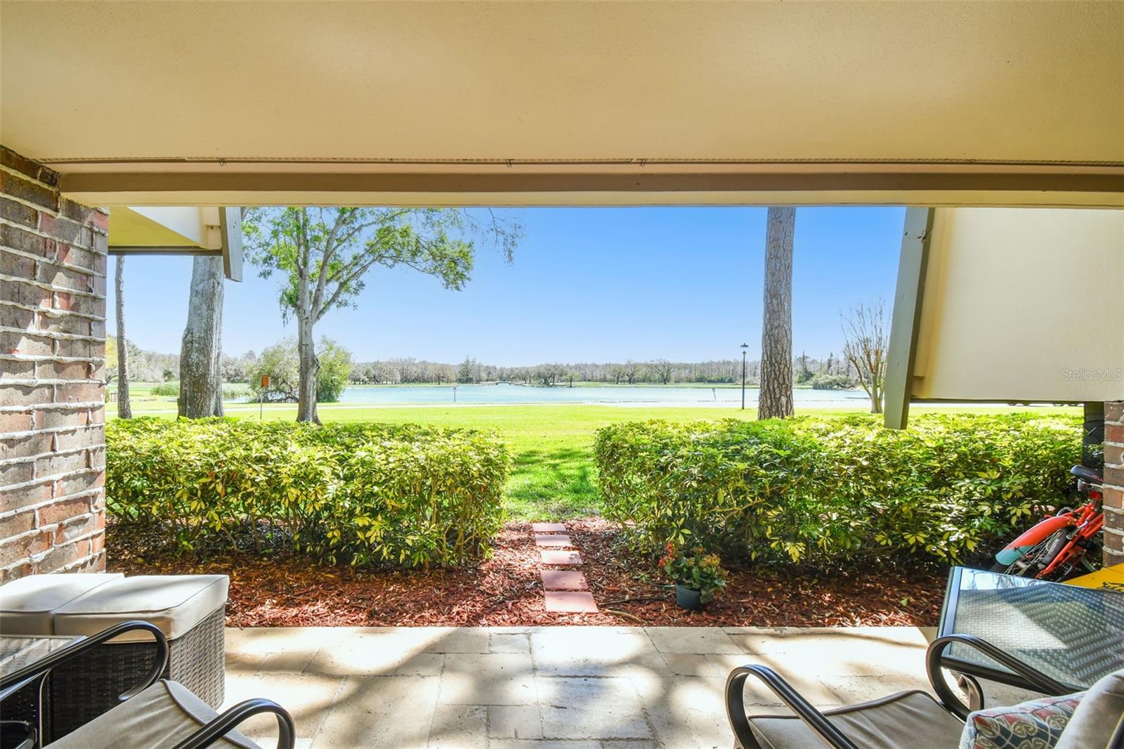 TWO BEDROOM/TWO BATH “C” UNIT - Ground Floor with million-dollar view of Innisbrook Lake! Paradise awaits with resort-style living at its finest. You will love this gorgeous 2-Bedroom/ 2-Bath condo with an UNOBSTRUCTED VIEW of the lake and Island Golf Course. All this and much more in Innisbrook Golf and Spa Resort, a privately gated Resort in Palm Harbor. This unit is recently RENOVATED FROM TOP TO BOTTOM, tastefully decorated, AND offered FULLY FURNISHED. Renovations include PELLA PREMIER IMPACT AND HURRICANE RESISTANT windows and doors which include a transferable 20/10-year warranty. As you enter this condo, you can appreciate the open concept kitchen, living and dining area. Enjoy the enlarged kitchen with classic high-end cabinets as well as extra storage, with stunning granite counter tops with LARGE ISLAND/BREAKFAST BAR with four bar stools and a pantry with pull-out drawers and appliance garage for coffee maker and toaster. HIGH-END APPLIANCES include induction stove, fridge with ice & filtered water, dishwasher and microwave. Beautiful Travertine Flooring in a French pattern matches throughout the kitchen, living room, patio, hallways and closets, as well as new flooring in both bedrooms. The guest bathroom has been completely renovated as well as the master bath has been enlarged and renovated with a vanity with double sinks. Other improvements you will appreciate are the Crown Molding throughout; Raised Ceiling in the kitchen; Wine Storage Rack and Mini Bar with Wine Fridge; LED pot lights throughout; and LED lights above and below kitchen cabinets adding ambience. An added benefit of this location is the Island Clubhouse is right next door featuring the Turnberry Pub and Island Pool with hot tub, as well as a ground floor coin-free laundry just a few doors away, or, you have the option to install your own washer dryer in the water heater closet (to be installed by a licensed plumber and permits are required). Your HOA fee is very inclusive with water/sewer/trash/coin-free laundry/Wi-Fi and basic cable all included.Situated on 800 wooded acres of rolling hills and 70 acres of lakes, Innisbrook, A Salamander Golf and Spa Resort is located just 25 minutes from Tampa International Airport. Innisbrook features sixty-three holes of golf, including the PGA’s Valspar Championship Copperhead course, 280spacious guest suites and rooms, 5 restaurants and 3 bars including the FAIRWAYS COFFEE AND WINE BAR featuring STARBUCKS coffee, 10 Har-Tru TENNIS courts, 4 Hard-court PICKLEBALL Courts, 3 Indoor RACQUETBALL courts, a full-service Salamander SPA with 12 treatment rooms and Fitness Center, 6 Swimming POOL Complexes, and 2 Conference halls.