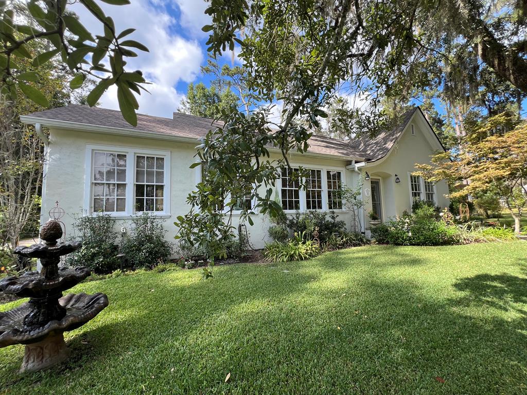 J.K. Harper Cottage sits in one of the most desirable in town neighborhoods complete with sidewalks and a beautiful park across the street. Nearly 100 years old and full of character this home has been lovingly maintained and updated for modern living. Inside you will find a bright welcoming living room with fireplace, formal dining room with built-in cabinets and a kitchen that blends modern convenience with vintage charm. Floorplan offers flexibility with a private office that could serve as a 3rd bedroom, a guest room and a primary suite with updated bath. Hardwood flooring throughout adds warm and timeless appeal. Outside is magic! Beautiful landscaping, fountain, and a lovely gazebo perfect for outdoor entertaining. The large lot (which possibly could be divided) also includes a storage building. A truly special home - classic South Georgia Charm!