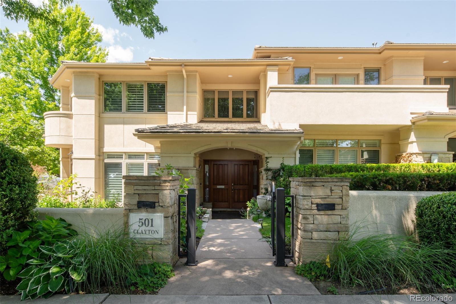 Corner townhome in the heart of Cherry Creek offering exceptional natural light and an elegant layout. A dramatic entry with soaring ceilings and a sweeping curved staircase sets the stage, opening to an expansive main floor. A sunken sitting room anchored by a double-sided gas fireplace creates an intimate, inviting space. The main floor opens seamlessly into a generous dining area and an open kitchen and living areas – wrapped by expansive windows. Upstairs, sits a spacious primary suite with a sitting area, fireplace, walk-in closet, and a large bathroom. An additional en-suite bedroom and a conveniently located laundry room round out the light-filled second floor. The finished basement with high ceilings includes a large recreation room, wet bar, wine storage, an additional bedroom, plus a full bathroom. A rare three-car attached garage, excellent storage, and multiple terrace spaces with are all set within lush surroundings. Located just moments from Cherry Creek North, enjoy Denver’s premier dining, shopping, and entertainment right outside your door.