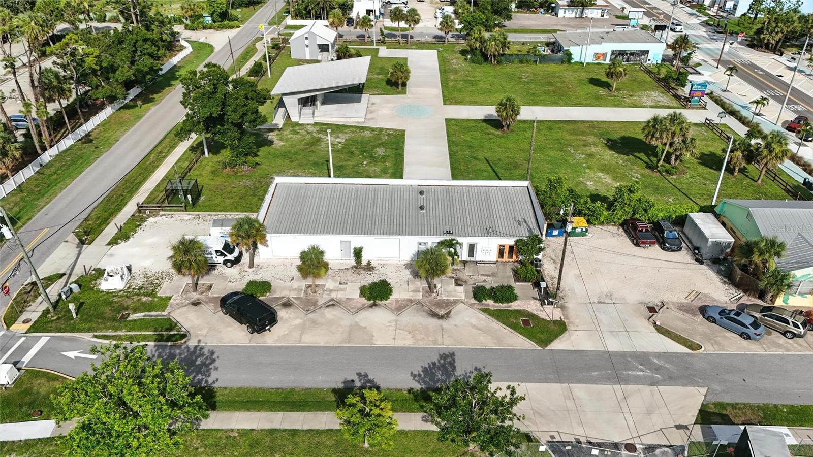 Under contract-accepting backup offers. Fantastic opportunity in the heart of Englewood’s Historic Dearborn District! This 2,700 sq ft freestanding concrete-block commercial building is zoned Commercial General with the special Historic Dearborn Street/Main Street overlay district, which significantly expands allowed uses and value. The overlay encourages pedestrian-friendly, mixed-use development and permits live/work or residential units above commercial space, with potential for up to three stories (35 ft maximum height). The site was previously approved to add a second story, offering excellent expansion potential. Current layout includes three roughly 900 sq ft units: one is fully built out with modern finishes and storefront appeal, while the other two are open block and concrete, ideal for warehouse, storage, or easy conversion to retail, office, studio, or retail! The overlay zoning also supports expanded ground-floor commercial space, with potential to add another unit or increase floor area for office or retail. Features include three separate electric meters for flexible multi-tenant setups. Dedicated side parking lot for 4–6+ vehicles with potential for more, plus additional public parking in front. The property backs onto county green space with an amphitheater, public restrooms, and lawns that regularly host concerts, festivals, farmers markets, and events, driving high foot traffic. The rear wall showcases Englewood’s iconic “Greetings from Englewood” mural, offering landmark visibility. Prime walkable location steps to Mango Bistro, restaurants, coffee shops, boutiques, and all the vibrant energy of Dearborn Street. Ideal for investors, developers, or business owners looking to capitalize on one of Englewood’s most sought-after and flexible commercial corridors.