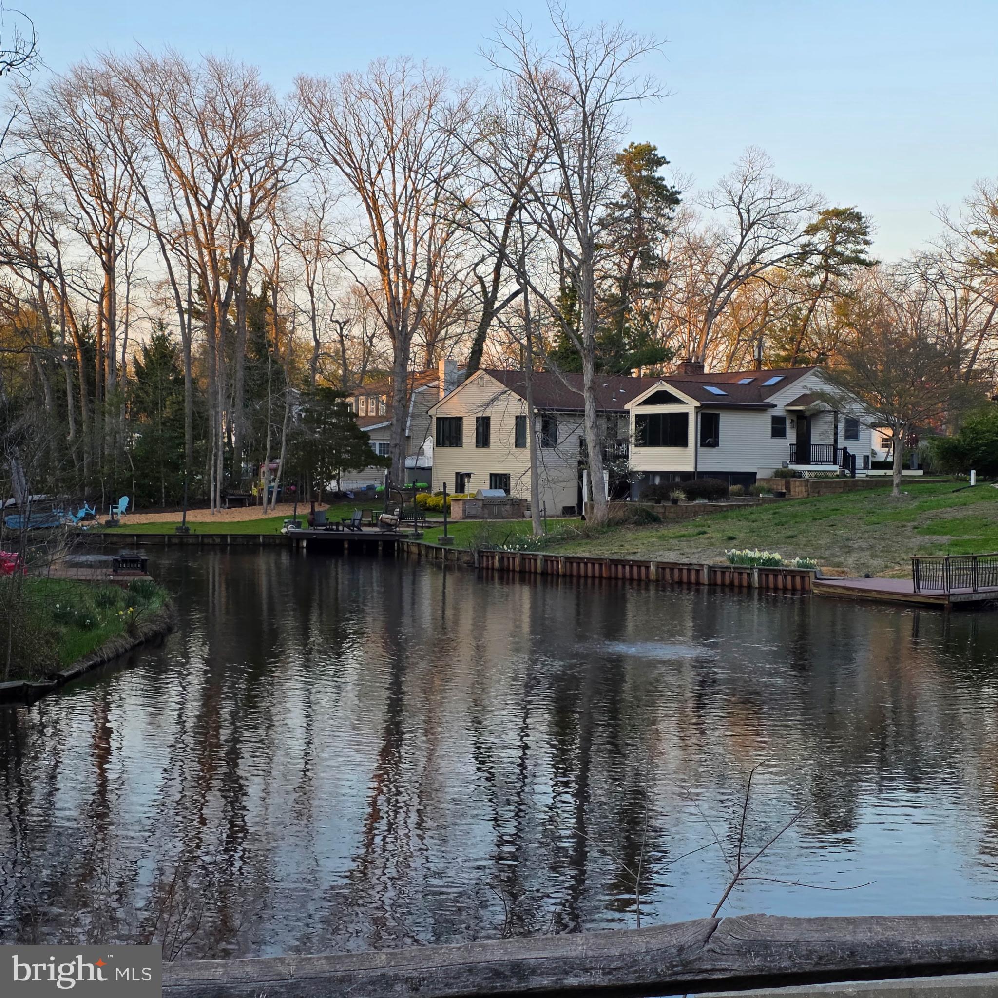 Welcome Home to This Exceptional Lakefront Rancher!Step inside this stunning 5-bedroom, 4-bathroom lakefront rancher, thoughtfully and completely remodeled in 2022 to offer the perfect blend of luxury living and private retreat space—designed for both everyday comfort and unforgettable entertaining.As you enter the main level, you’re immediately drawn into the retro-modern living and parlor space, where expansive sightlines lead straight through to the deck and sparkling lake views. Anchored by a custom live-edge wood mantel, this inviting space sets the tone for the home—warm, stylish, and effortlessly connected to the outdoors. Step out onto the upper-level deck to take in peaceful water views and the natural beauty that surrounds the property.Just beyond the living space, the heart of the home awaits: a show-stopping chef’s kitchen professionally designed by a renowned chef to maximize both function and style. Culinary highlights include an 8-burner Jenn-Air range with double ovens, an additional third wall oven, commercial-grade hood ventilation, pot-filler  and a brand-new smart refrigerator with touchscreen access—perfect for recipes, streaming, or staying connected while you cook. Vaulted ceilings with electric skylights flood the kitchen with natural light, enhanced by Andersen windows featuring professional UV tinting for improved energy efficiency. Panoramic lake views make dining at the table or relaxing on the kitchen sofa an everyday experience.Continuing down the hallway into the west wing of the main level, you’ll find a thoughtfully designed bedroom layout featuring  a private primary suite with en-suite bath and wraparound windows offering breathtaking 180-degree lake views. Two additional bedrooms and a full bath complete this wing, ideal for family or guests. This level also provides convenient access to the laundry facilities and direct interior entry to the heated two-car garage, which is equipped with EV charging, making the home both comfortable and future-ready.Make your way downstairs to the walkout lower level, which offers exceptional flexibility and can easily function as private guest quarters or an in-law suite. This level features a spacious family room with coffee/wet bar, a full guest bedroom, and a full bathroom—perfect for hosting or extended stays. Continue into the lower west wing to discover a secluded primary-style retreat complete with its own exterior entrance, private office, and spa-inspired bathroom featuring heated floors, a soaking tub, open tiled shower, and custom his-and-hers walk-in closets with private laundry.Step outside to your resort-style backyard, where lake living truly shines. Enjoy a covered patio, screened porch, outdoor Viking chef’s kitchen, and a newer dock overlooking the lake—ideal for fishing, paddle boating, or simply watching the birds and turtles glide by. The property features a lake-water–supplied sprinkler system to keep the landscaping lush and efficient, along with an electric dog fence that extends into the lake, offering a safe and secure environment for pets to roam and even enjoy dog-friendly swimming.Additional highlights include a custom outdoor storage shed, a charming front porch—perfect for sipping your morning coffee—and thoughtful systems that enhance ease of living year-round.This one-of-a-kind lakefront home offers space, flow, modern convenience, and an exceptional lifestyle—inside and out. This home won't last. Schedule your viewing now - Open's April 15th!