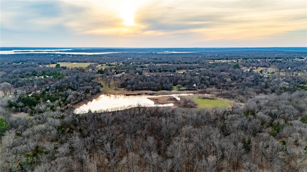 A true outdoor paradise tucked just minutes from Norman, yet offering the kind of seclusion and habitat that’s getting harder to find this close to the city. Spanning 62.89 +/- acres, this property is loaded with water, featuring a 3-acre stocked pond that at times reaches 10 acres in size, an overflow pond, and a winding creek channel that together create year-round attraction for wildlife. The landscape is a beautiful blend of mature oak, pine, pecan, and hickory timber mixed with native grass openings, plum thickets, and established food plot locations. Stands are already in place and will convey with the sale. Heavy rub lines, consistent trail camera activity, and even a giant non-typical buck confirm what the habitat suggests — this property has the nutrition, genetics, and cover to grow and hold mature deer.The main pond is stocked with bass, crappie, and bluegill, offering year-round fishing, while ducks and geese are frequent visitors. Whether it’s casting a line in the evening, watching waterfowl work the ponds, or slipping into a stand on a cool fall morning, this property delivers the kind of everyday enjoyment most people only dream about.The 2,755 sq. ft. home (per appraisal) offers 4 bedrooms and 3.5 bathrooms, including a mother-in-law suite, with a wood-burning fireplace and large picture window overlooking the pond. A second 500 sq. ft. 1 bed, 1 bath home provides excellent guest or rental potential. The 40x60 shop features three bay doors, insulation, heat, a butcher room, and walk-in cooler. Located just 3 minutes from Lake Thunderbird boat ramp, 20 minutes to Norman, and 30 minutes to OKC.