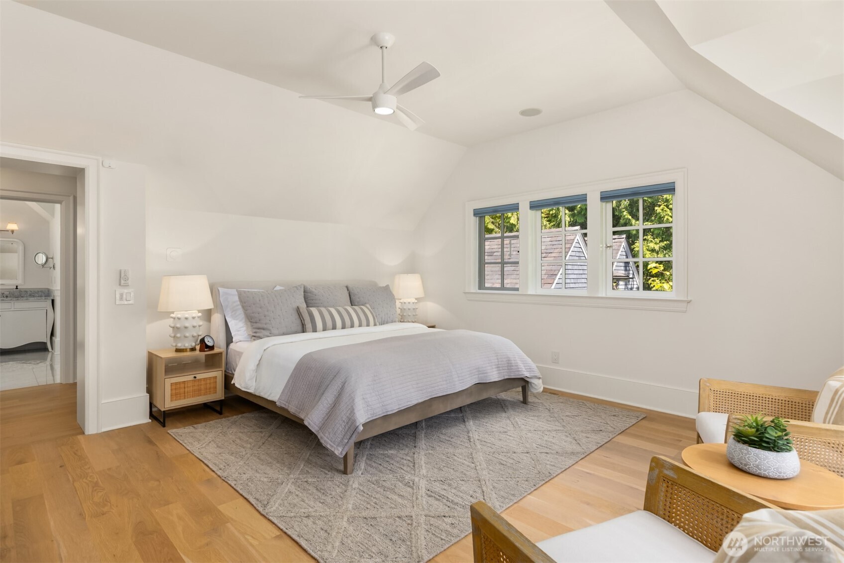 Spacious bedroom featuring vaulted ceilings and an en-suite bathroom.