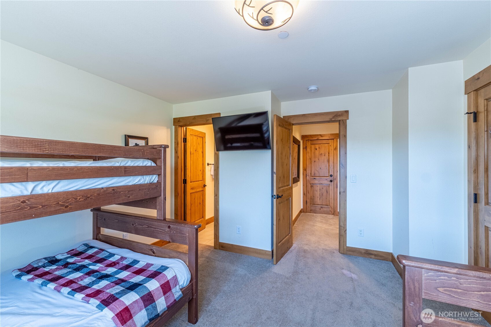 Versatile bunkroom with two full beds and two twin beds, offering comfortable accommodations for all ages