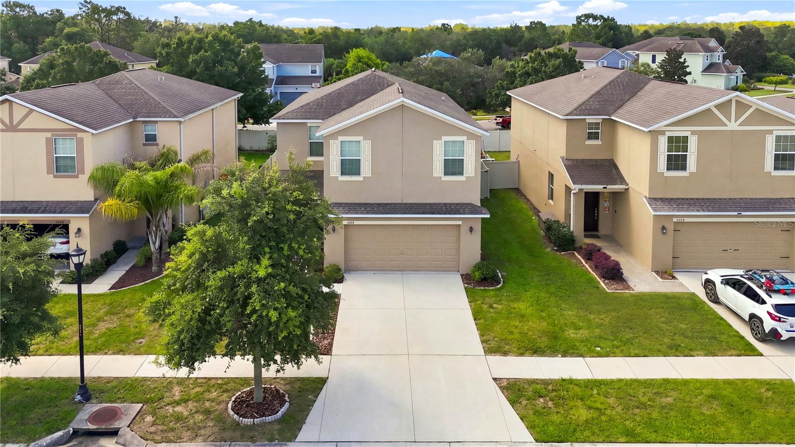 Picture the end of a busy Tampa workday: you arrive home, pull into the convenient 2-car garage, and step easily inside near the kitchen—then the pace slows. At 13752 Reindeer Circle, an inviting open main level brings the great room, dining area, and kitchen together for effortless family time and entertaining. Sliding doors lead to a covered lanai and a large, privacy-fenced backyard—your own space for morning coffee, weekend play, or evening gatherings. Upstairs, four generous bedrooms provide room for everyone, while the flexible layout gives a growing household space to spread out. Located in the desirable Lakeside community, residents enjoy a beautiful amenity center, pool, sports, and activities. With convenient access to the Suncoast Parkway and I-75, this is where commuting to Tampa meets coming home to the lifestyle you deserve. New Water Heater 2025, stone counter tops, recessed lighting, large tile flooring in kitchen and baths, covered lanai with fenced back yard, water system, Hurricane Shutters, Blink door bell system among some of the features this home offers.