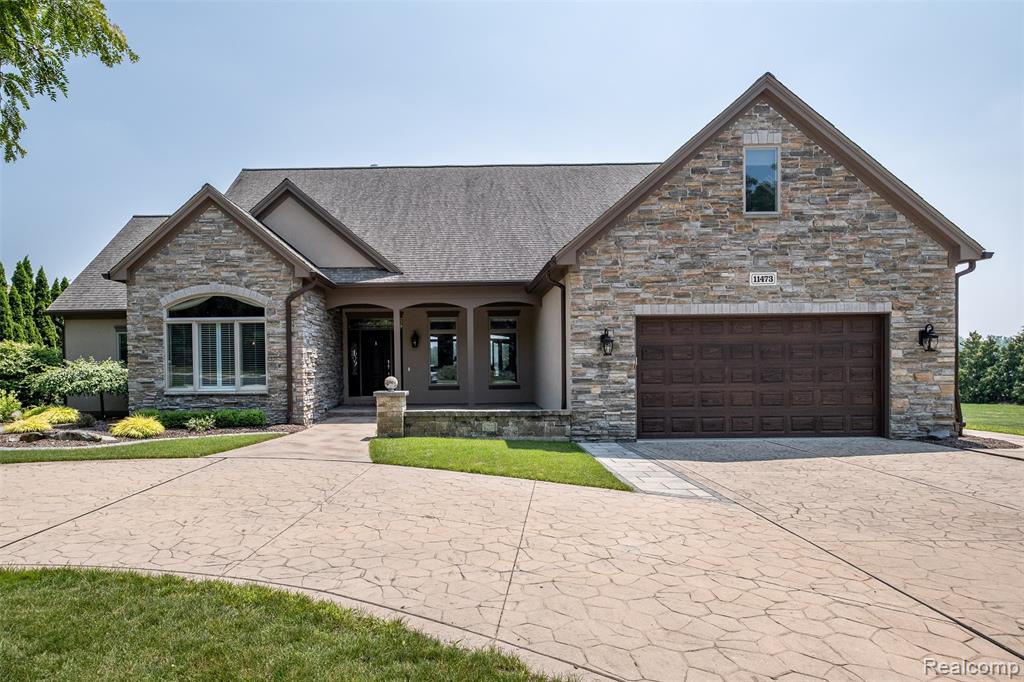 Welcome to your dream lakefront escape on stunning ALL SPORTS LAKE FENTON! Nestled quietly on Bay Shore Drive, this exceptional property offers 113 feet of pristine waterfront with panoramic views from nearly every room. This 5-bedroom, 3 full & 2 half bath home is an entertainer’s dream and a serene private escape. Step inside to find an open-concept living space flooded with natural light. The airy layout has soaring ceilings, an abundance of natural light with panoramic lake views throughout. The main level highlights include an expansive primary suite with elegant finishes throughout, heated floors, soaking tub, walk-in shower, california closet system, private access to the upper deck for serene & stunning lake views. Additional bedroom with ensuite, first floor laundry & access to the refinished 2 car garage. Upstairs you will find a large room with a walk in closet & new mini split for temperature control. The walkout basement is designed for both relaxation and entertainment, featuring a beautiful wood bar, butlers pantry and sauna creating the ultimate in-home spa experience.  With additional laundry, full & half bath and plenty of storage throughout. Two additional bedrooms provide flexible living/guest space. Outside, enjoy your private oasis with 113 feet of lake frontage, boasting multiple gathering areas—perfect for making unforgettable memories with family & friends! An outdoor kitchen, hot tub, firepit, beautifully landscaped yard and expansive entertaining space are perfect for hosting summer gatherings or enjoying quiet mornings by the water. This home offers an unmatched lifestyle. Enjoy every season with seamless indoor-outdoor living and lakefront lifestyle amenities. Whether you're enjoying a quiet evening by the fire pit, soaking in the hot tub, or entertaining on the patio, every detail of this home is thoughtfully designed. Don't miss your chance to own a slice of paradise on Lake Fenton—where every day feels like a vacation.
