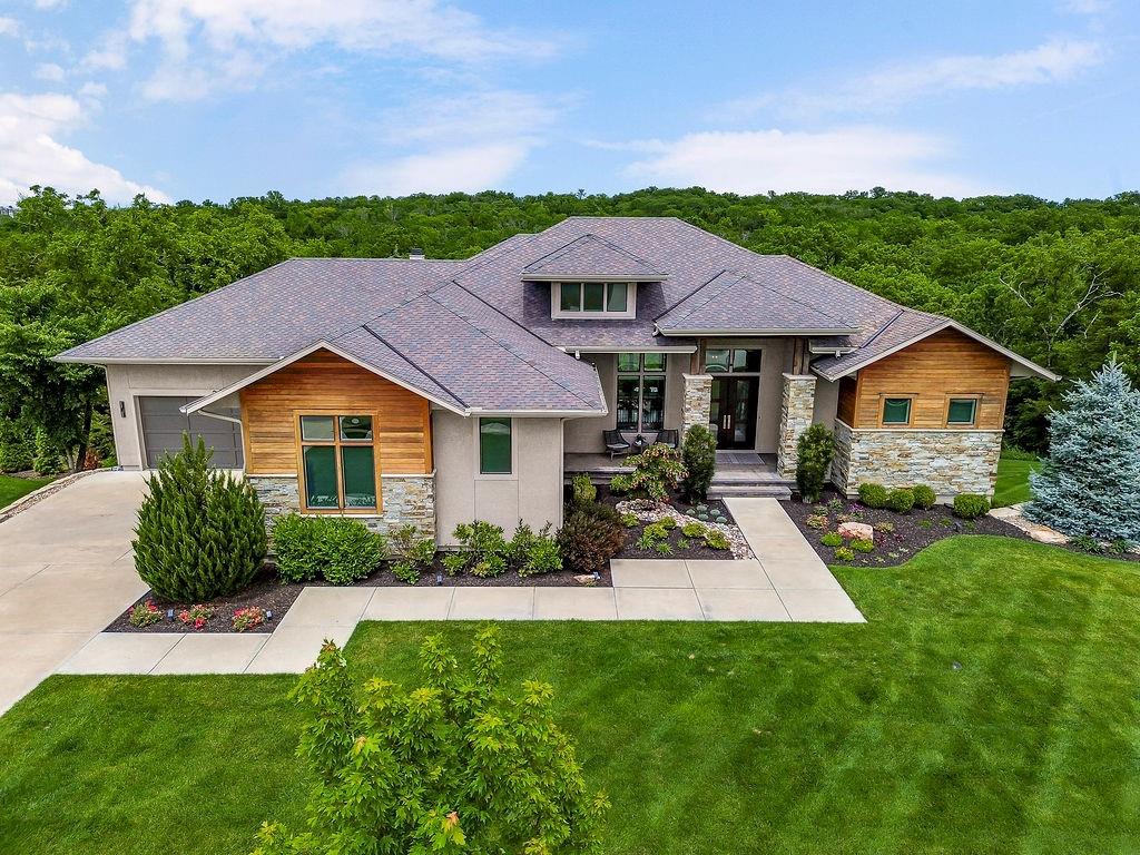 A spectacular Rev. 1.5 sty., custom built by Starr Homes and offers exceptional privacy!  Located on a quiet cul-de-sac in the Hidden Lake Estates neighborhood of Cedar Creek, this home backs east to densely treed greenspace and includes a stunning salt-water pool, extensive outdoor living space, a fenced backyard & L-shaped 4-car garage!  Open concept plan features a vaulted Great rm. w/stacked stone FP & wood beam accents! Designer kitchen w/huge island, high-end appliance package, prep kitchen & walk-in pantry! Luxurious primary suite w/double shower heads, free-standing tub & custom 2-sided closet!  Versatile 2nd bedroom on the main floor is currently utilized as a home office w/direct access out to a 23 x 16 covered deck with FP & built-in grill!  Walkout lower-level boasts 10' ft. foundation walls, 2 bedroom suites, 2.5 baths, Family/Media rm., Rec. rm., wet bar, exercise room & 145 sq ft walk-in safe rm.  This home has been very well cared for & shows like new!