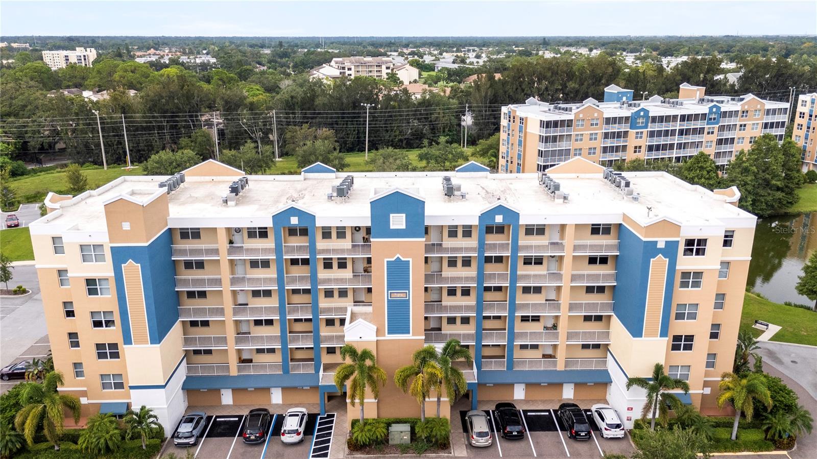 One or more photo(s) has been virtually staged. Welcome to this  beautifully maintained 2-bedroom, 2-bath turn-key condo in the desirable Golf Lake Condos community which offers comfort, convenience, and peace of mind. The unit features a private balcony, a modern kitchen with appliances just 1.5 years old, and a newer A/C unit only one year old. The spacious primary bedroom features a large en suite with two walk-in closets for his and hers. No need for a laundry facility. This unit offers your very own laundry closet with a washer and dryer for convenience. This condo is equipped with a modern tankless water heater for endless on-demand hot water and a water softener system that helps protect appliances and provides fresh, high-quality water throughout the home. A designated parking space is located directly in front of the building, with guest and second-vehicle parking nearby. Everyday living is made easy with a trash chute just steps away, along with close access to the elevator and mailboxes. Building 5, known for its all-concrete construction, exceptional design, management, and maintenance, features concrete block exterior walls and walls between condos ensuring durability, safety, and energy efficiency minimizing heating and cooling costs. Residents benefit from a completed Structural Integrity Reserve Study with minor issues already addressed, and no milestone inspection required until 2037. Building 5 is also elevated, high and dry, with NO EVACUATION NECESSARY. The south front exposure shields the living room and primary bedroom from the hot direct afternoon sun reducing A/C costs and allowing year-round enjoyment of your screened in lanai. The community offers two sparkling in-ground spas and a resort-style clubhouse, while relatively low HOA fees cover insurance, grounds and building maintenance, pool, clubhouse, water, sewer, trash, cable, high-speed internet, and fully funded reserves. Surrounded by abundant wildlife and natural beauty, Golf Lake provides a tranquil retreat with easy access to beaches, shopping, dining, entertainment, and Florida’s top attractions. Schedule your showing today!