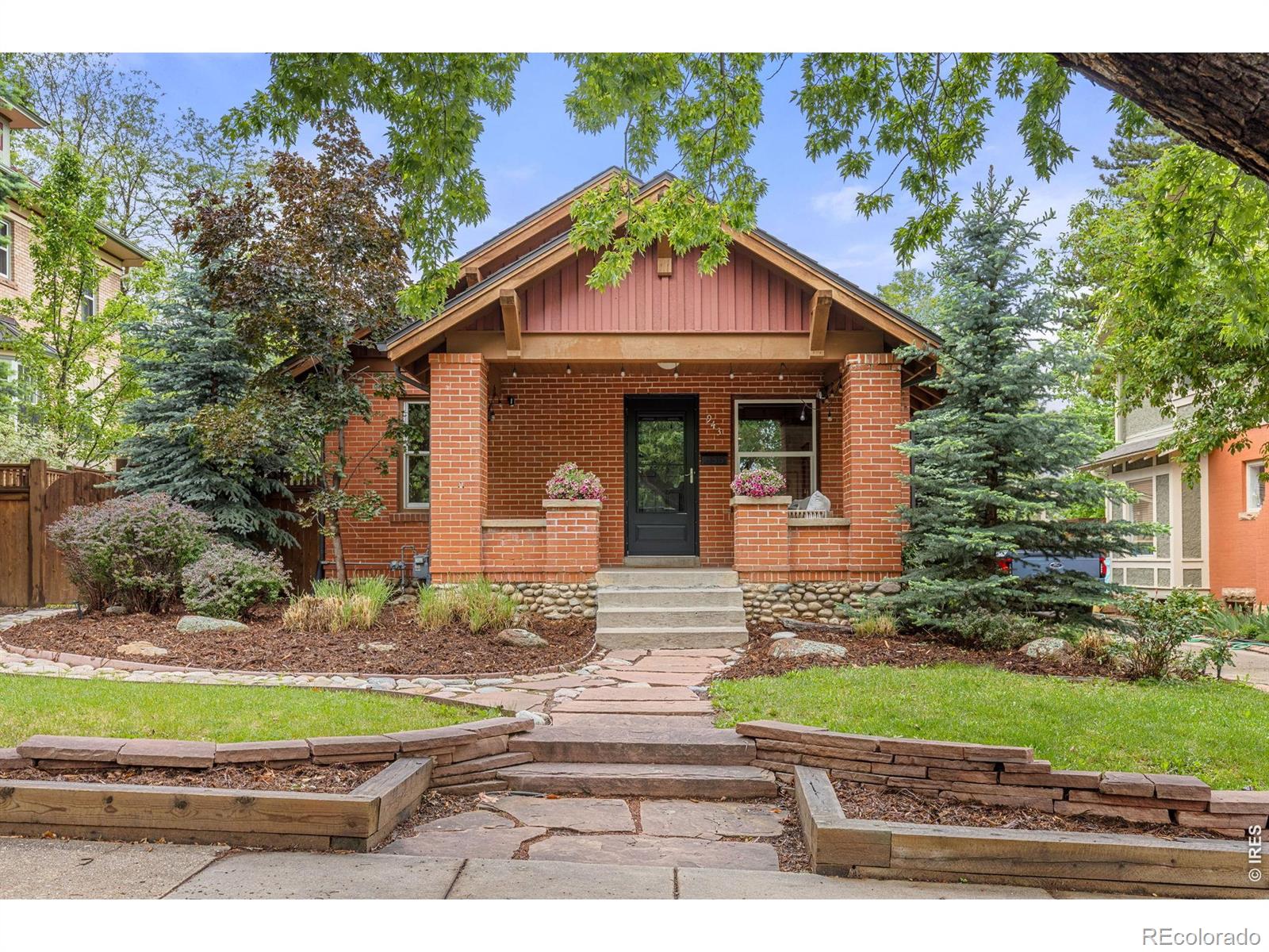 Welcome to life in the heart of Boulder! If you've ever dreamed of waking up just blocks from Chautauqua Park with the Flatirons as your daily backdrop, this is the one. Tucked into one of the most beloved streets on The Hill, this classic bungalow puts everything that makes Boulder special right outside your front door - endless hiking and running trails, restaurants, coffee shops, music, downtown Boulder - all within walking distance.The historic charm is real: step onto the classic bungalow porch and inside hardwood floors and big windows with original wood moldings, and built in shelving, give it that warm character that's hard to find. The main level has a smart layout - a primary bedroom with a large beautiful bath and walk-in closet, a dedicated office or bedroom, and an additional bedroom and bath, so the space truly works for how people live. The kitchen is the heart of it all - a stunning setup with a huge island, gas stove, tile-brick accents, and stainless appliances. Whether you're cooking for two or hosting a crowd, this kitchen delivers. Step down to the lower walk-out level and you'll find a 4th larger bedroom perfect for guests or a rec room, an updated 3rd bathroom, and a dedicated laundry room. Out back is where summer comes alive. The fully fenced, landscaped yard is made for morning coffee, backyard dinners, and those long Colorado evenings with a cathedral seating patio that's an entertainer's dream. And the oversized 2-car garage? A rare find in this part of town with plenty of room for all the outdoor gear that comes with the Colorado lifestyle. Classic bones, thoughtful updates, unbeatable location. Homes like this on The Hill don't come around often!