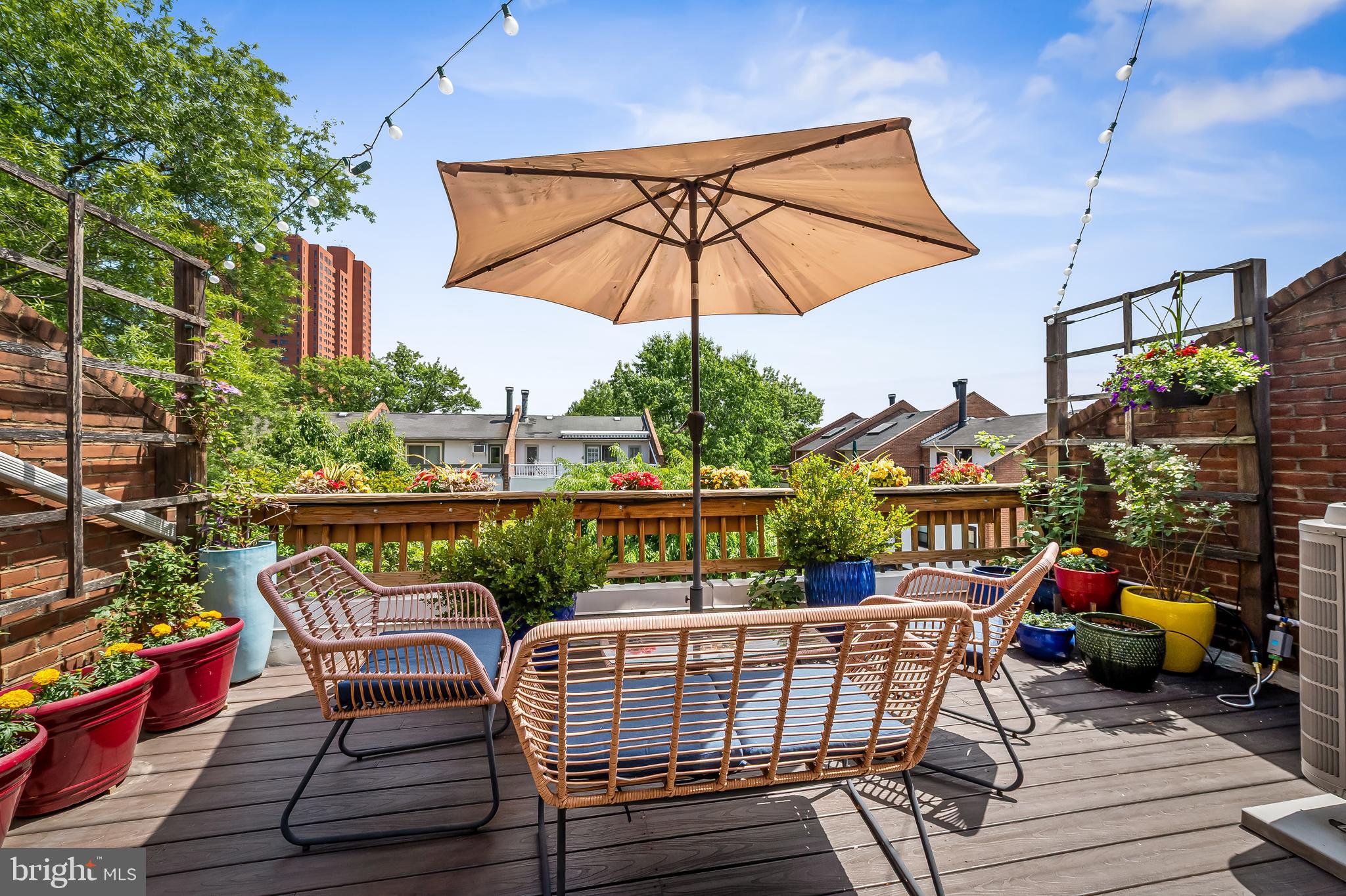 Location, location, location! Prime location in the quiet Otterbein neighborhood, steps away from gorgeous parks  and a short stroll to the MARC train, stadiums, Inner Harbor, and all downtown Baltimore has to offer. Stylishly updated Otterbein home with rare 2-car parking pad and EV charger. Bright, open main level with hardwood floors, wood-burning fireplace, powder room, and  white kitchen with stainless appliances, eat-in space, and great storage. Upper level features two spacious bedrooms and two renovated full baths. Top floor is a sun-filled primary suite with walk-in closet, separate HVAC, and private terrace with gorgeous city views.  Designer-inspired finished lower level with full bath, laundry, and private entrance—ideal for guest suite, office, or flex space. This home offers move-in readiness, space, convenience, and character in one unbeatable location.