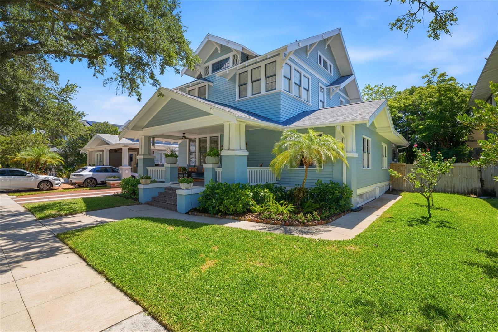Located on a quiet, oak-lined street just 1/2 block from Bayshore Boulevard, this historic Hyde Park residence offers a rare combination of timeless character, walkable convenience, and exceptional flexibility. From your front door, enjoy a 10-minute stroll to Hyde Park Village, an easy bike ride to Downtown Tampa, Water Street, and Benchmark Arena, and convenient access to Gorrie Elementary and Wilson Middle School, and Plant High School (all A-rated).Originally built in 1906, this home has evolved thoughtfully over the years while preserving the architectural charm that makes Hyde Park so beloved. Expansive front porch, original hardwood floors, a welcoming foyer, beautiful staircase, and wood-burning fireplace create a warm sense of history, while modern updates provide comfort and peace of mind.Spanning 2,331 square feet, the home offers an incredibly versatile floor plan with 4 or 5 Bedrooms (depending on use) and 4 full bathrooms, including two primary suites. A first-floor primary suite provides an ideal setup for multigenerational living or long-term guests while an additional flexible front room can function as a living room, home office, or fifth bedroom with convenient access to a full bath.The remodeled kitchen serves as the heart of the home, connecting seamlessly to the family room and outdoor living spaces. Upstairs, the second primary suite is a light-filled retreat with an ensuite bath. And the two additional bedrooms have access to the hall bathroom. Above, a full stand-up attic presents additional expansion opportunities rarely found at this price point in Hyde Park.Major capital improvements have already been completed, including a brand-new roof (June 2026), upgraded electrical service (2024), new under-house ductwork (2024), central HVAC installed in 2016, and a generator-ready electrical transfer switch with natural gas hookup capability for added storm preparedness.Outside, the 5,940-square-foot lot offers remarkable future potential. The large backyard provides room for a pool, home expansion, or outdoor entertaining space, while the garage is already equipped with electric, water, and sewer connections, creating exciting possibilities for a future studio, workshop, or guest quarters (ADU).Mature landscaping, a productive mango tree, charming curb appeal, and a welcoming community of longtime neighbors further enhance the property’s appeal.For buyers seeking historic Hyde Park character, modern infrastructure, flexible living arrangements, and an unbeatable location near Bayshore Boulevard, this is an opportunity not to be missed.