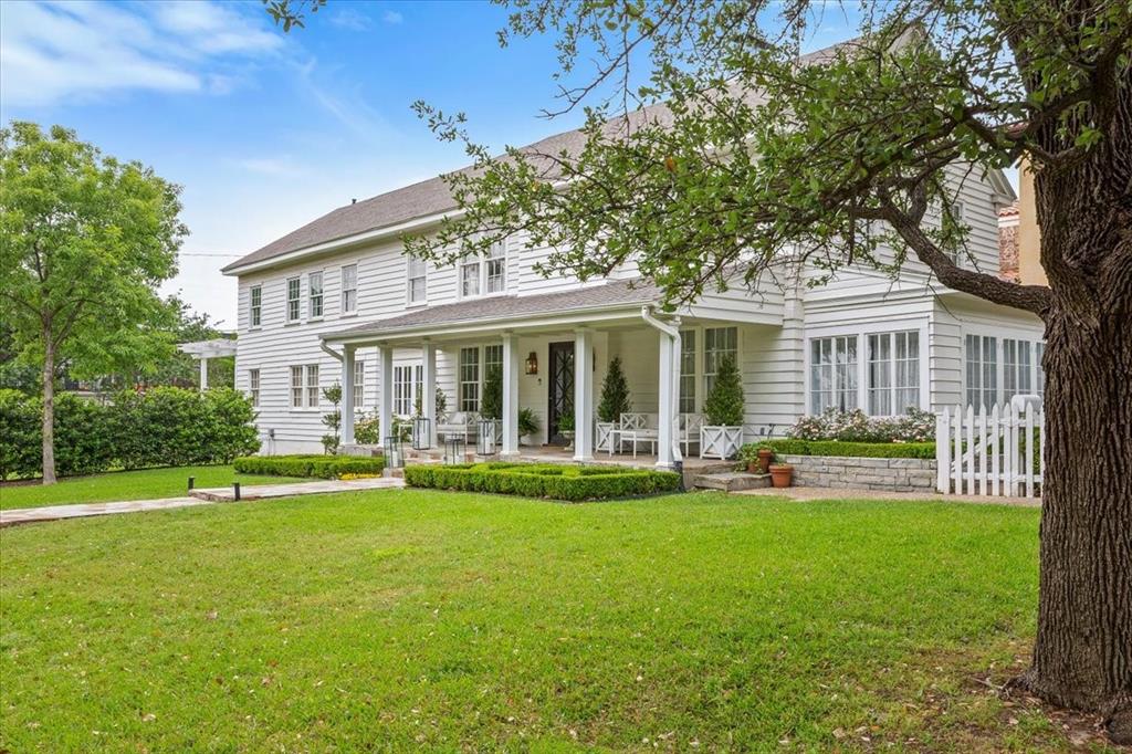Perched on a beautiful corner lot within walking distance to River Crest Country Club, this stately three-story home offers an extraordinary blend of timeless elegance and refined design. A classic white picket fence and gracious covered front porch create a warm, inviting presence in one of Fort Worth’s most beloved neighborhoods. Inside, rich hardwood floors, intricate crown molding, and grand-scale formals define the home’s traditional character. The interiors are curated with intention—think marble fireplaces, antique-inspired lighting, and classic millwork throughout. The formal dining room is a showpiece with its ornate chandeliers, detailed trim, and sophisticated palette, while the oversized living area provides space for both entertaining and everyday living. The kitchen is beautifully appointed with custom cabinetry, marble countertops, and a built-in breakfast banquette that brings both charm and function. Each bedroom has its own personality, and the bathrooms feature statement wallpaper, curated lighting, and designer finishes. Upstairs, the primary suite is an elegant retreat with paneled walls, custom drapery, and beautifully detailed cabinetry in the bath and dressing areas. Curated fixtures throughout the home give it a layered, high-end look. Outside, manicured landscaping, mature trees, and charming outdoor seating areas complete the picture—all just a quick stroll or golf cart ride to River Crest Country Club. This is a rare opportunity to own a truly special property that brings together architectural beauty, thoughtful updates, and a coveted location.