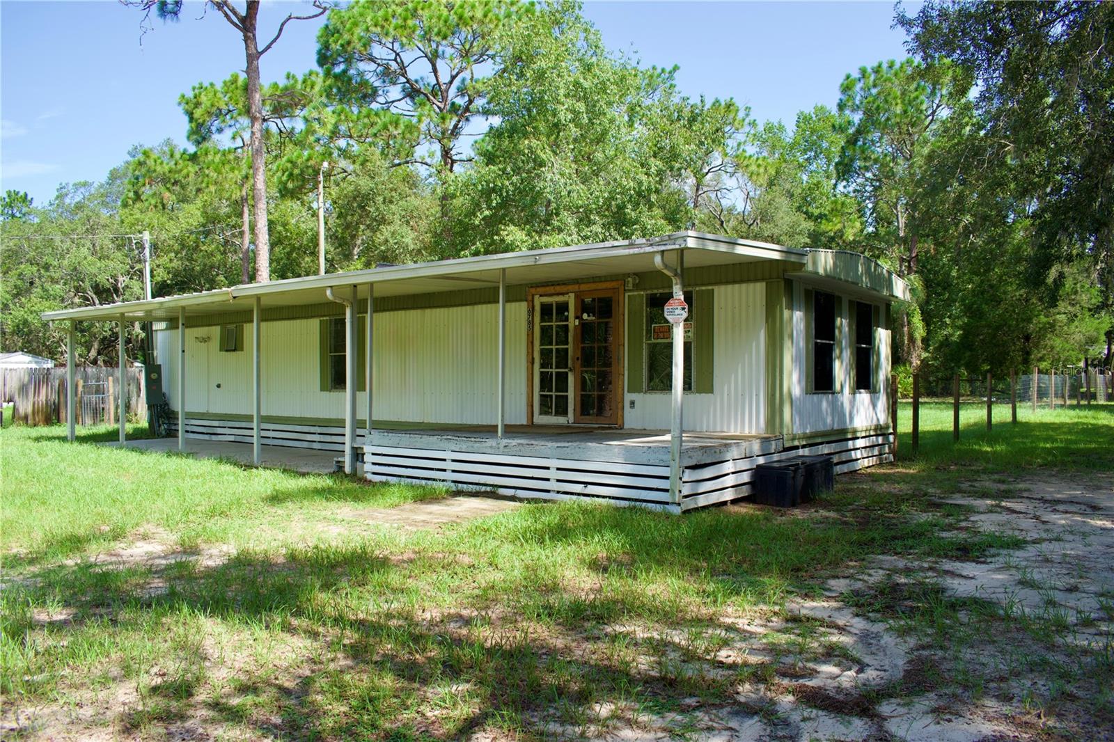Peaceful country living on half an acre. In an idyllic rural setting, this home offers an affordable opportunity for a full-time residence, seasonal retreat, or simple homestead-style property.The owner completed several important functional updates within the past 4 years, including attractive new flooring and subflooring, new ductwork, A/C system, kitchen cabinets and countertops. The private well is functioning properly, and the septic system has been recently serviced. So much space outside—a covered porch & patio, fenced backyard, a separate area for pets, front fence and gate, chicken coop, animal pen, and an RV hookup.Bring your ideas and enjoy the quiet setting, outdoor space, and laid-back lifestyle on Florida's Nature Coast.