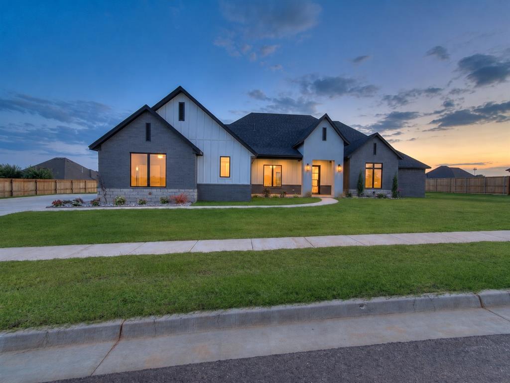 Modern design meets exceptional functionality in this stunning custom home, where soaring ceilings, taller doors, and expansive picture windows fill the space with an abundance of natural light. Large-format tile flows throughout the main living areas, creating a clean, sophisticated aesthetic that perfectly complements the home's contemporary style. The chef-inspired kitchen is both beautiful and practical, featuring Forno appliances, a built-in microwave, walk-in pantry, oversized island with abundant storage, and a refrigerator that remains with the home. Just beyond the kitchen, a spacious second living room or bonus room with custom built-ins offers endless flexibility for entertaining, a media room, or play space. Designed with everyday living in mind, the oversized laundry room includes a utility sink, built-in drying rack, and exceptional storage. A mud bench welcomes you from the garage, while an additional flex room with its own garage access creates the perfect space for a home gym, art studio, hobby room, workshop, or additional storage. The thoughtfully designed split floor plan provides privacy, with a luxurious primary suite showcasing beautiful trim details, wood beam ceilings, and private access to the backyard. A convenient half bath serves guests, while every detail throughout the home reflects quality craftsmanship and intentional design. Step outside to enjoy the expansive covered patio, perfectly positioned with a north/south orientation for comfortable shade throughout the day. Thoughtful exterior up-lighting and down-lighting enhance the home's striking curb appeal after sunset. From its elevated finishes to its versatile layout, this home truly offers a level of design and functionality that is rarely found. Property is also shop approved!