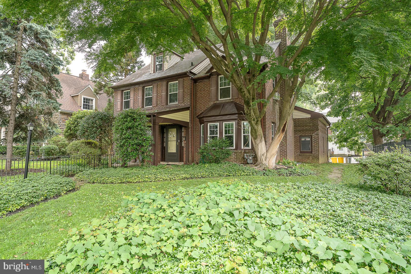 Welcome to 52 Rock Glen Road, a beautifully maintained 5-bedroom, 4-full-bathroom center hall Colonial offering 2,232 square feet of flexible living space in the award-winning Lower Merion School District. A charming covered front porch sets the tone, welcoming you into a classic home that blends timeless character with modern updates. The spacious living room features gleaming hardwood floors, crown molding, custom built-ins, and a cozy wood-burning fireplace, creating the perfect setting for relaxing or entertaining. The formal dining room, accented with chair rail and crown molding, flows seamlessly into the updated eat-in kitchen, complete with granite countertops, stainless steel appliances, abundant cabinetry, and a bright breakfast area. A door from the kitchen leads to the rear patio and level backyard, offering an ideal space for outdoor dining, play, or gardening.The first-floor primary suite offers exceptional flexibility, with a walk-in closet, a full ensuite bathroom, and a private exterior entrance, making it an ideal in-law suite, guest quarters, or private home office. Upstairs, the second floor features two generously sized bedrooms connected by a Jack-and-Jill bathroom with a tub, an additional bedroom, and a full hall bathroom. The third floor offers a private fifth bedroom and full bathroom, perfect for guests, teens, or an additional home office. The unfinished basement includes a laundry area, abundant storage, and excellent potential for future finished living space.Ideally located just minutes from shopping, dining, parks, major roadways, and public transportation, this home offers an easy commute to Center City Philadelphia while providing the charm and convenience of one of the Main Line's most desirable neighborhoods. A rare opportunity to own a spacious, versatile Colonial in an exceptional location.