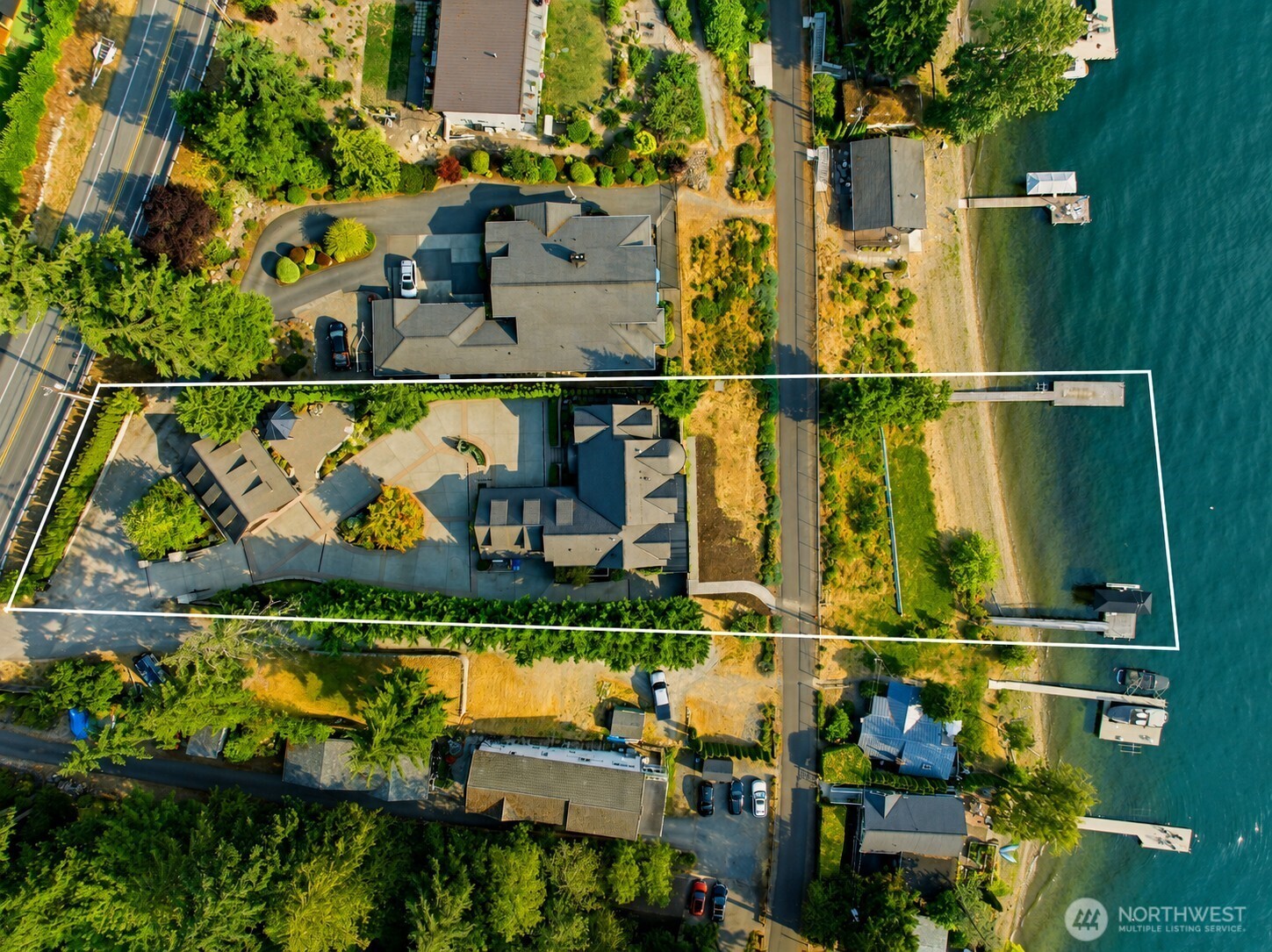 Street-to-water waterfront property showcasing the full estate from the road to the shores of Lake Sammamish.