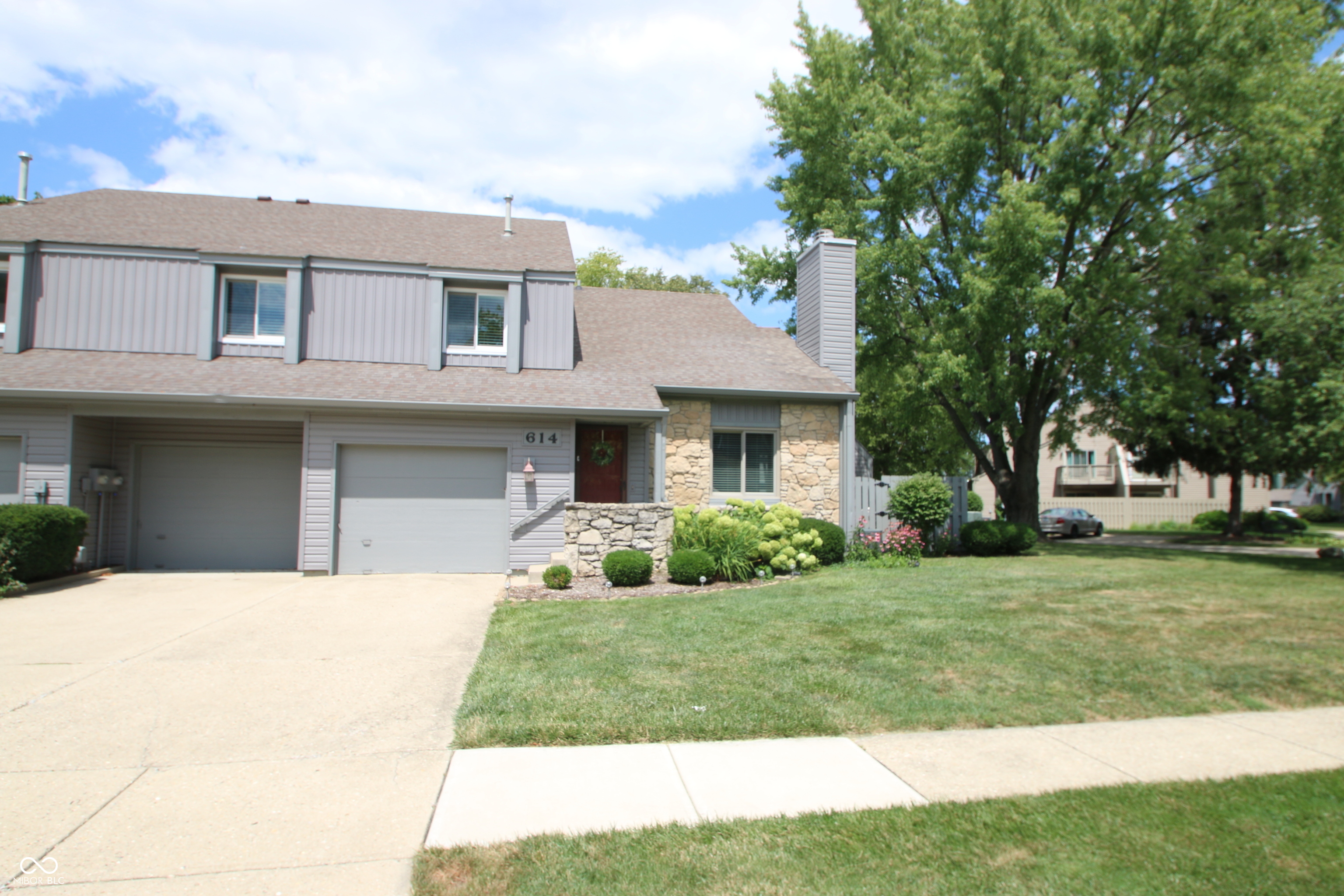 This beautifully updated condo is in the ideal location and is ready for you to make it your home! Step in to find an open floorplan, spacious great room with vaulted ceiling, gas fireplace, dining room and breakfast bar with a patio view, all surrounding the well appointed kitchen. On the other end of the kitchen you'll find the laundry closet, a bathroom and access to the spacious garage that includes a wall of built in shelving and a separate climate controlled bonus room with built in desk for use as an office, workshop, craft room or storage area. Upstairs you'll find the versatile loft area that makes a great office or additional guest space that includes a large closet. (This could be a 3rd bedroom if you added a wall in place of the railing and a door.) A full bathroom is right around the corner and across from the 2nd bedroom. The private primary suite is beyond the next doorway with a large dual sink vanity, separate toilet, tub shower room, large bedroom and walk-in closet. With brand new flooring and fresh paint throughout, all new siding, windows, blinds, patio fence, pergola and the fact that all appliances stay, so all you have to do is move in and enjoy! This home has one of the larger lots, but don't worry, lawn maintenance and snow removal is taken care of. Enjoy the outdoors on the very private and beautifully landscaped patio and know that the pool and common area is located right across the street. Walk in either direction to find a large variety of restaurants, shops, the new Kroger Marketplace, parks and all that downtown Fishers has to offer, just down the street! Don't delay, schedule a showing today!