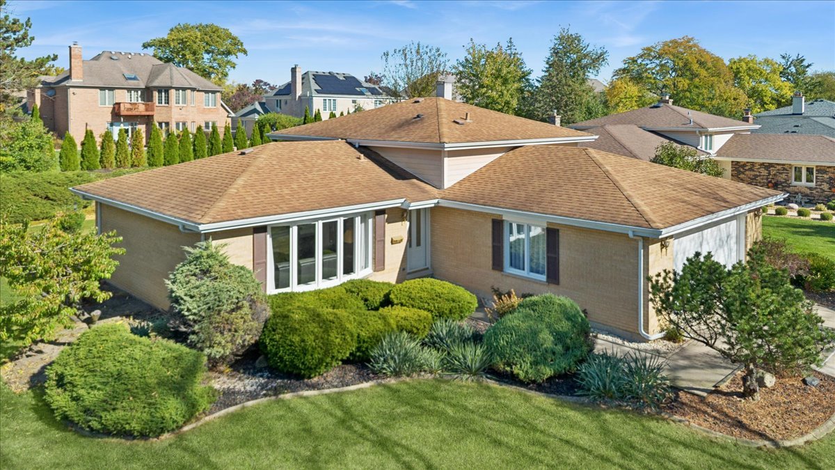 Impeccably maintained 3-bedroom, 2-bath home offers timeless finishes with a highly desirable Darien location. Upon entering, you are welcomed by hardwood floors flowing across both levels, creating an elegant foundation throughout the home. The sun-filled kitchen offers an elevated everyday experience with maple cabinetry, granite countertops, and eating-bar-an ideal space to enjoy morning coffee while overlooking the tranquil backyard setting. The home's layout features well-sized bedrooms, generous closet space, and a versatile lower level perfect for a secondary living area, home office, or a fitness space. A spacious laundry room delivers exceptional storage and functionality. Recent mechanical updates include a newer AC unit and a water heater.  The backyard faces the desirable Darien Club, offering peaceful and serene views. Whether entertaining or unwinding, the outdoor environment elevates the experience.  Perfectly situated near top-rated schools, parks, shopping, dining, and major expressways, this home delivers a unique combination of quality, comfort, and opportunity. it is a true gem in an exceptional location!