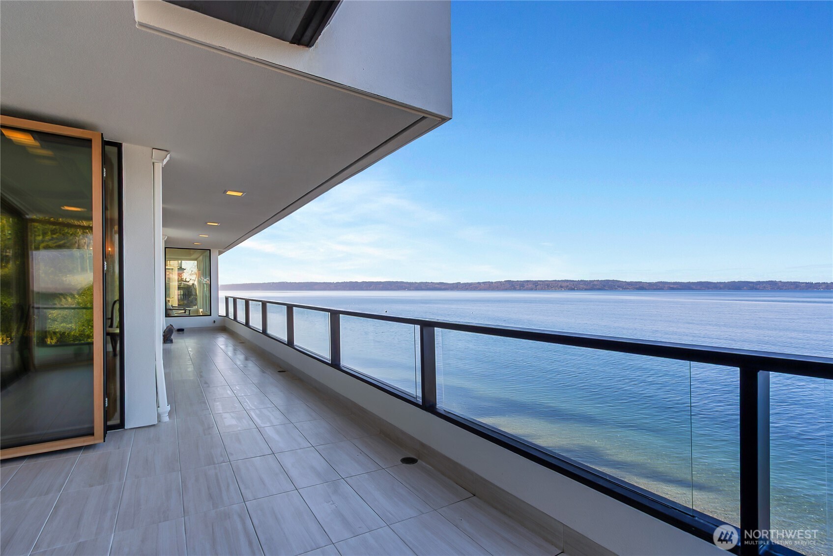 Rare, low bank waterfront with 122’ of pristine sandy beach.  Experience coastal living in this exceptional 3-story home, perfectly positioned along the sound with panoramic sunset views that can be enjoyed from every floor. The chef’s kitchen features custom cabinets and exquisite quartzite countertops.  Spa like bathrooms with elegant finishes. Giant windows capture the view in almost every room including a beautiful LaCantina 4 panel bifold door. This home is a true sanctuary of comfort and style.