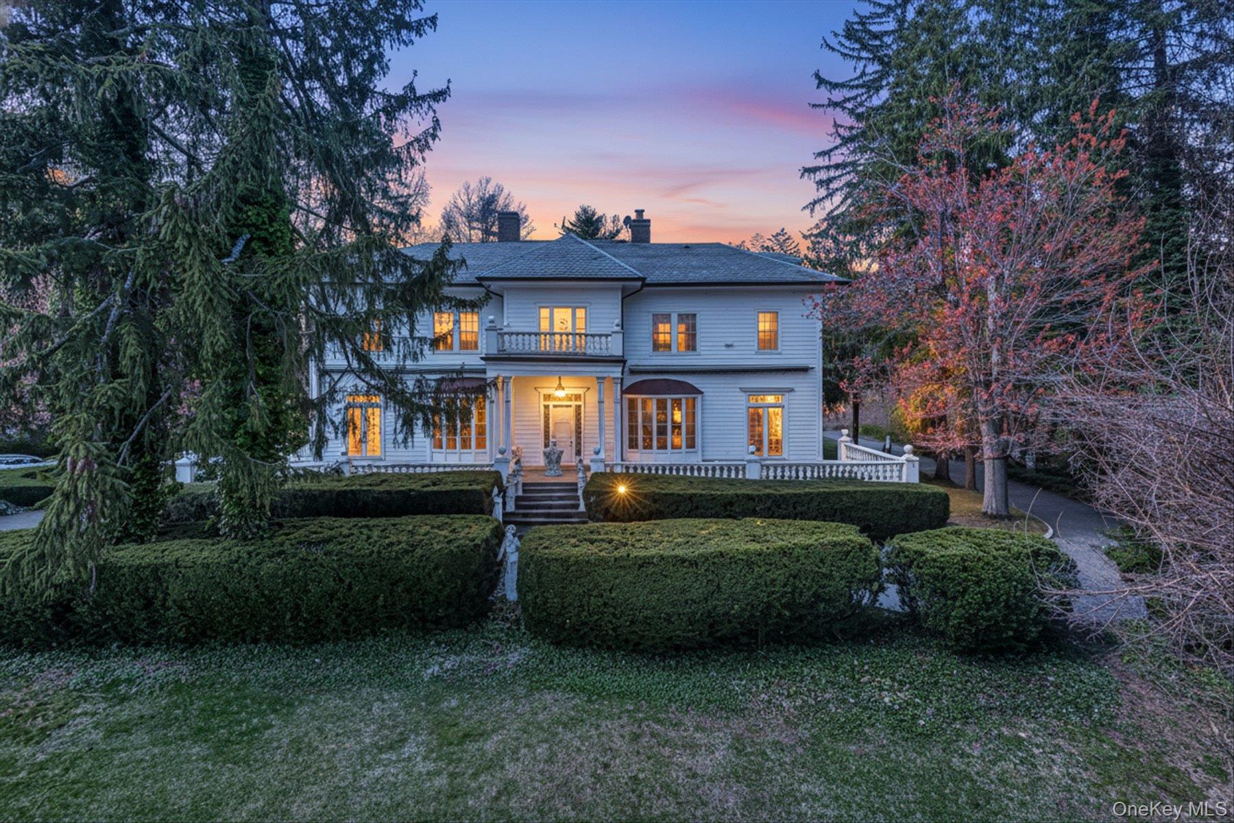 Welcome to a distinguished waterfront residence in the prestigious village of Kings Point, offering expansive, unobstructed views across Manhasset Bay and an exceptional opportunity to experience the Gold Coast lifestyle at its finest. Privately set behind mature, manicured landscaping, this stately estate embodies timeless elegance, scale, and sophistication. The home’s classic architecture is highlighted by a grand columned portico, upper-level balcony, and a beautifully balanced facade that creates a striking arrival experience. Spanning approximately 5,500 square feet, the residence is defined by gracious proportions, refined details, and a layout designed for both formal entertaining and comfortable everyday living. Sun-filled interiors showcase oversized windows that frame the home’s sweeping water views, while a series of elegant living and dining spaces flow seamlessly throughout. French doors open to inviting outdoor patios, creating a natural extension of the interior and offering the perfect setting for entertaining against a serene waterfront backdrop. The second level features five well-appointed bedrooms, including a tranquil primary suite positioned to capture elevated views of Manhasset Bay. The home is complemented by seven bathrooms (four full and three half), thoughtfully designed to accommodate both residents and guests. A full attic provides additional space with endless potential for customization. The property’s lush grounds offer privacy and tranquility, with manicured hedges, mature plantings, and multiple outdoor seating areas designed to embrace the surrounding natural beauty and water views.Ideally located within one of Long Island’s most coveted waterfront communities, this exceptional offering is moments from marinas, parks, and the refined amenities of the North Shore. A rare and compelling opportunity to own a classic estate with enduring character, remarkable scale, and breathtaking water views in an unparalleled setting.