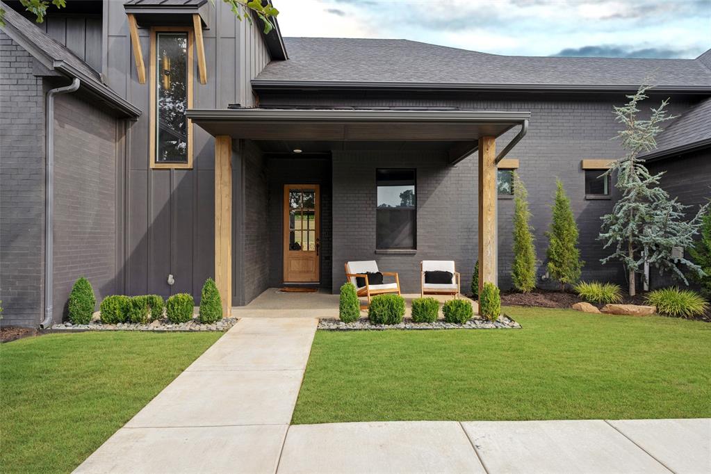 On a generous 3/4 acre lot, this former Parade of Homes property balances scale, function, and style. With five bedrooms, three and a half baths, multiple living areas, a study, chef’s kitchen, 20x30 shop, and private basketball court, it was designed with both everyday living and entertaining in mind. From the entry, thoughtful details begin to unfold—a pocket office tucked neatly off the foyer, a powder bath positioned with guests in mind. The main living area is defined by vaulted ceilings and wide sliding doors that frame the backyard, filling the space with light and creating a natural extension outdoors. The kitchen blends performance and design: professional-grade appliances, a built-in refrigerator, sleek countertops, and a walk-through butler’s pantry. The adjoining dining area, lined with picture windows, is anchored by a sculptural chandelier and built-in buffet. The primary suite offers a spacious bedroom and a bath appointed with dual vanities, walk-in shower, freestanding tub, and understated lighting. The custom walk-through closet connects directly to the utility and mudroom, a practical detail that simplifies daily routines. Three additional bedrooms on the main level share a full bath, each finished with a distinct design perspective. Completing the first floor, a moody bonus room—flexible enough for a fifth bedroom, theater, playroom, or lounge—sits just off the living room. Upstairs, a secondary living area, fifth bedroom, and full bath provide space for guests or family. Outdoors, a covered patio with a fireplace anchors the backyard. Beyond, a playset, trampoline, and basketball court leave room to spare for a pool—turning the property into a true extension of the home.