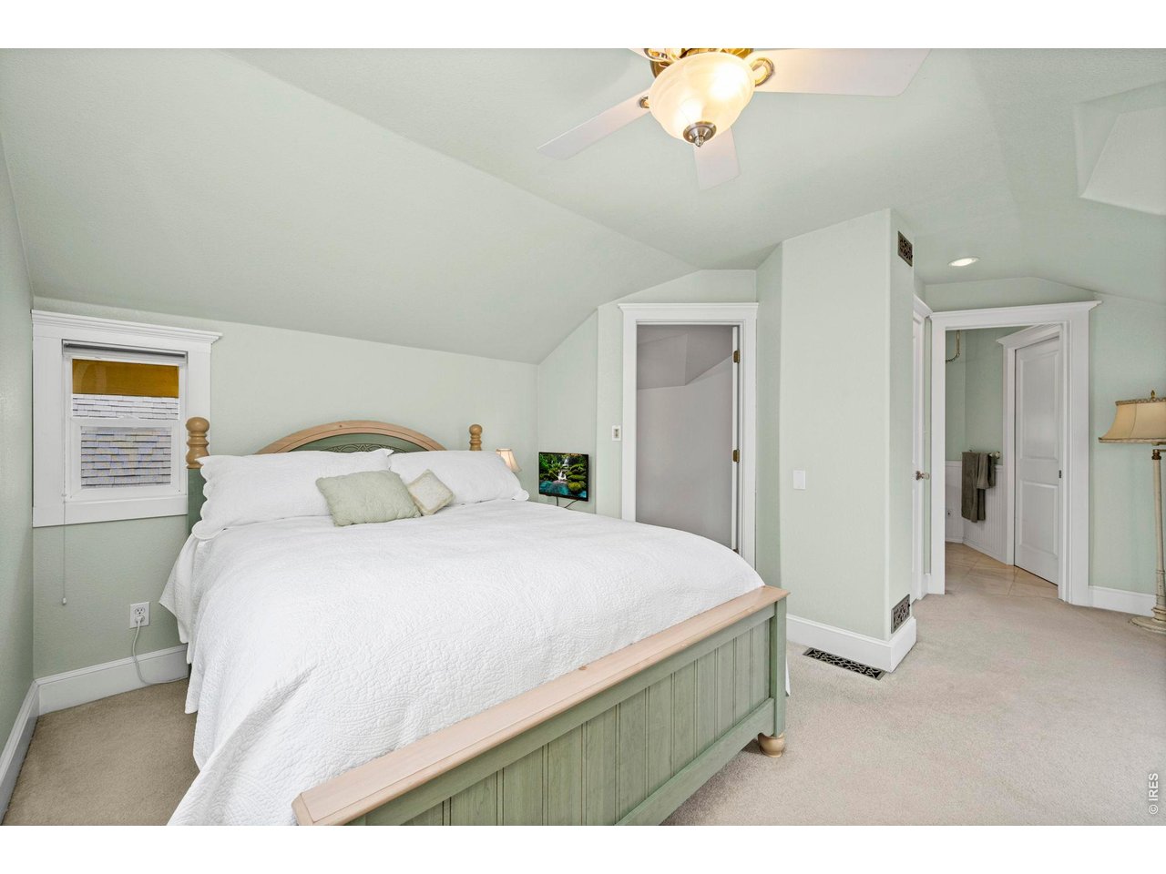 Welcome to this charming two-story home in the heart of Loveland. Ideally located just minutes from vibrant downtown, library, Chilson Rec Center, and many of the area's local shops, restaurants, and parks. This home offers both convenience and character in one of Loveland's most desirable central neighborhoods. Front steps lead up to a welcoming porch, creating a warm first impression. Inside, the main level is filled with natural light and features beautiful wood flooring throughout. Elegant arched doorways and a charming bay window highlight the living room, which also features a cozy free-standing fireplace that adds warmth and character to the space. The front living room flows seamlessly into the kitchen, highlighted by eye-catching blue cabinetry and stainless steel appliances, including a dual-fuel range. A redwood side deck is located just off the kitchen. The main floor also offers a flexible layout with a dining room, spacious family room featuring a second free-standing fireplace, a main-level bedroom, a 3/4 bathroom, and a dedicated craft room or hobby space. The main living areas connect to the expansive back deck overlooking the large, gorgeous backyard. The outdoor space is a standout feature of the home including mature landscaping, with fruit trees galore, perennial flower beds, a vegetable garden, and a recently added privacy fence. A detached extended one-car garage with alley access provides convenient parking and storage. Upstairs is the primary suite featuring a spacious bedroom with its own balcony overlooking the backyard-perfect for enjoying your morning coffee. The primary bathroom includes a clawfoot slipper tub with shower attachment and two closets providing ample storage. The finished basement adds even more versatility with an office space, laundry area, and unfinished storage. Don't miss this rare opportunity to own this charming home with beautiful gardens and generous outdoor space located in a prime Loveland location.