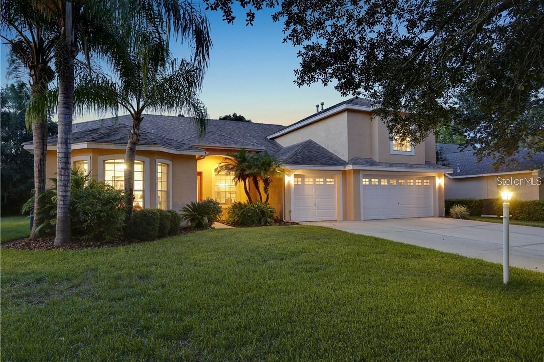 Under contract-accepting backup offers. In the Heart of Tampa Palms lies this lovely retreat to welcome you home after a hard day at work. This home has been impeccably maintained. Lots of laughter, family parties, and social events have taken place within these walls. This home is ready for its next owner who is ready for their paradise. With 5 bedrooms and 4 baths there is plenty of space for the whole family. Holidays can bring the extended family to together with over 3,500 sq ft of living space to entertain in. A triple sliding door from the living room is just one way the home connects to the large screened in pool area. The cooler temps can be enjoyed by simple opening those doors and the living room has been extended! Being screened in also means you can enjoy you evenings bug free! While enjoying the outside the views of the pond and conservation area are all you see. Your backyard has only side neighbors and the yard has natural barriers for privacy.