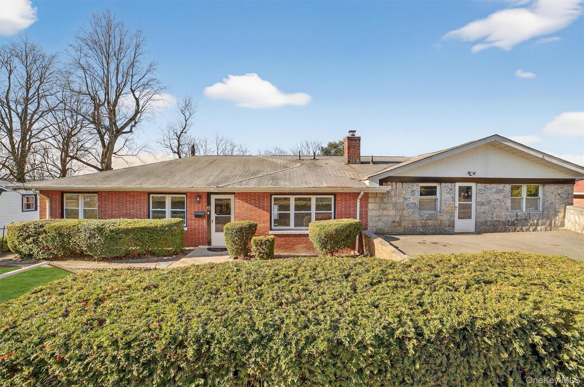 Great opportunity in the sought-after Woodstock Park neighborhood. This sprawling ranch with an exceptional layout and seasonal Hudson River views offers a flexible floor plan ideal for extended or multi-generational living. Set on a beautiful property, the home provides generous space and outstanding versatility throughout.The main level welcomes you into an inviting entrance hall that opens to an oversized dining room with seasonal river views—perfect for gatherings and entertaining. The large living room, also featuring seasonal river views, offers a door leading out to the patio, creating a seamless indoor-outdoor flow. The kitchen features an open layout with a breakfast island.Also on the main level are three bedrooms, including a primary bedroom with a private bath, two additional bedrooms, and a full hall bath. The main living area also leads to a separate wing offering two versatile rooms that can be used as dens, home offices, or additional guest bedrooms. This area includes a separate entrance, making it ideal for extended family living, guest quarters, or a private workspace.The lower level provides substantial additional living space, featuring a very large family room, summer kitchen, additional living area, office or guest bedroom, an additional den or second office, and a full bath—perfect for entertaining or multi-generational use. The lower level offers walk-out access to the backyard, which features a wonderful combination of deck, patio, and grassy outdoor space.A separate structure provides excellent potential as a studio, home gym, or creative retreat. A long driveway accommodates up to four cars.Don’t miss this opportunity to own a unique home in a beautiful setting, conveniently located just moments from parks, buses, trains, major highways, and the scenic Hudson River.