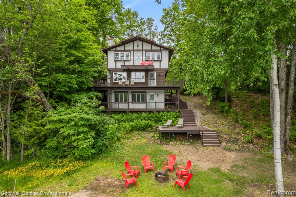 184'lake frontage of All-Sport Big Lake in Gaylord!  Immaculately maintained 4 bedroom 4 bath three level Chalet style home nestled in a lovely park-like setting with beautiful new composit decking to enjoy the stunning lake and wooded views. Complete with 2 wood burning fireplaces, 2 family rooms, updated kitchen with newer floors, backsplash and granite counter and appliances, fully remodeled wet bar with granite counter, fully finished walk out lower level with spacious family room (wood burning fireplace) , new bath and fourth bedroom with egress window.  Enjoy the open concept main floor with wood burning grand stone fireplace with new mantel and walk out to your extra large raised patio to extend your living space.  The upper level houses the expansive primary suite complete with en suite bath, vanity, walk in closet, and private balcony as well as two other bedrooms (with private balconies) and a full bath.  New attic insulation and roof in 2022, Newer zoned boiler and water heater. Septic pumped and inspected in 2022, chimney inspected in 2022, New built in microwave in 2024.  The lake is clear spring fed 80' feet at the middle with sandy lake frontage. The lot has peaceful woods as well as a beach area and sun deck.  Dock, and most furniture/housewares included.  Nothing to do but move in and enjoy the lake!

 All information deemed reliable but should be verified by buyer. Agent owne