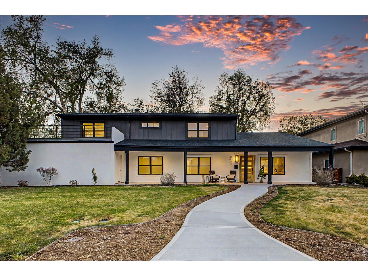 A full-scale renovation of a 1950s University Hills home, thoughtfully reimagined with 3,515 square feet, 4 bedrooms, 3 baths, and a level of finish and design rarely found in the area. The main level is anchored by a striking kitchen and living space, where a navy island with quartz countertops, custom cabinetry, and high-end appliances flows seamlessly into the dining area. A dramatic coffered ceiling creates a defined yet connected space, while a concealed-entry walk-in pantry, hidden behind custom cabinetry, adds both function and a refined design element. Expansive glass doors open to the backyard, creating a true indoor-outdoor connection. The primary suite spans the full width of the upper level, offering generous proportions, a dedicated sitting area, and direct access to a private deck. The ensuite bath features a freestanding soaking tub, glass-enclosed shower, dual vanities, and refined material selections, complemented by a custom walk-in closet system. Three additional bedrooms provide flexibility for guests, office space, or long-term living needs, while an upper-level loft/office offers a separate, versatile area for work or relaxation. Outdoor living is equally well considered, with a covered patio designed for relaxed, shaded seating and a separate open-air patio ideal for dining and entertaining, all set within a private backyard with professionally updated landscaping and drip irrigation. Extensive upgrades include new windows, roof, Trex decking with custom metal railing, multi-zone mini-split HVAC, updated plumbing and electrical components, a new water heater, and designer lighting throughout. A three-car garage adds significant functionality and further enhances the overall scale of the home. Across from Eisenhower Park and Recreation Center. Easy access to trails, courts, and fitness, with Cherry Creek and Wellshire Golf Course minutes away.