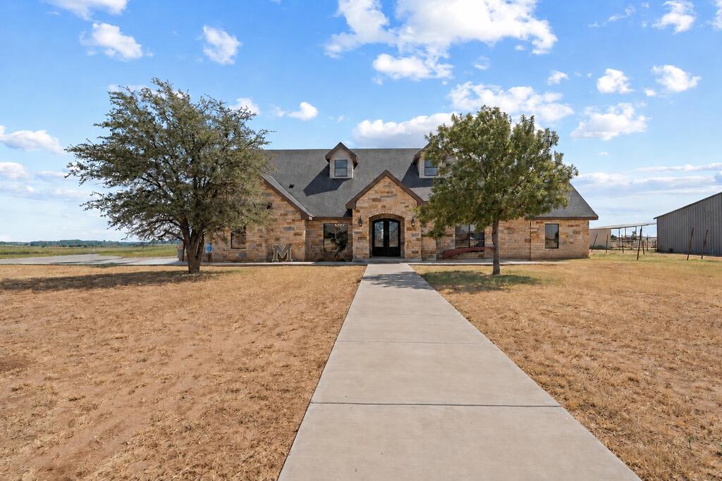 Beautifully crafted custom-built ranch style on a peaceful 1-acre setting near Greenwood's new schools. White-stone arches, timeless design and natural wood floors create a warm, inviting feel. The spacious kitchen features a gathering island, double ovens and a large gas range. Enjoy two living areas, a theater room, game room, private office and sequestered primary suite. Combining country tranquility, modern convenience and exceptional space, this remarkable home offers quality, style and value in a rare package.Exceptional value compared with nearby properties