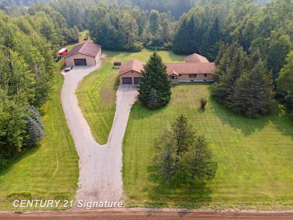 Noteworthy on Nine Mile! This Stick built 2280 sq feet of Phenomenal floorplan in this beauty which includes not 1, but  2 Master suites, one with an enormous walk in closet and an extraordinary, serene and expansive Master bathroom including a jet tub and beautifully tiled walk in shower just like your own spa.  There is also another large bedroom and an office or could be a 4th bedroom if you add a closet! 3 Full bathrooms, A lovely and substantial kitchen with granite counters, pantry and a nice sized dining area.  There is also a Living room with a pellet stove that can heat the entire house pretty well leaving the master a bit cooler for restful sleeping.  The spacious Family room looks out over the deck at the vast back yard and the remainder of the 35.53 acres with approximately 8 foot deep pond and immense woods in the background.  The Nice big mudroom/entryway leading from the attached 2.5 car with 8 foot tall doors and a 3rd door off the back is a added delight and the full unfinished basement is ready for you to finish and add extra living space! Plus the 40x64 Pole barn with it's own separate driveway, 220, 100amp electrical service, 12 foot tall walls and 10 foot high door.  The extra cabinet for over the oven/range is in the garage so it could easily be restored to it's original spot and you could lower the microwave if desired.  The flooring in the kitchen, living room, dining room and family room is solid laminate bamboo that can be refinished. Don't forget the magnificent hunting you could have in your own backyard as you can see from the photos. There is a culvert in the back of the property for the kids to catch crawdads and certainly enough room to grow your own vegetables if desired. The road is supposed to be being paved on Friday, August 8, 2025.  Seller would appreciate at least 30 days occupancy in the pole barn.
