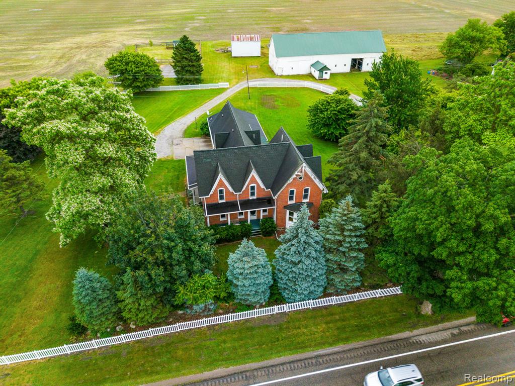 Welcome home to this gorgeous Victorian brick home on 5 BEAUTIFUL acres! With views of farmland and wildlife this property is ideal for peace and tranquility! Step inside with over 3700 sq ft of living space this home features, natural wood floors throughout, updated kitchen with eat-in island and a separate dining room! Natural gas fireplaces in both dining room and living room, along with custom built-in bookshelves. With FIVE bedrooms and an additional office this home has all the space you will need! Three FULL bathrooms, including a large primary ensuite with dual vanity amd separate soaking tub and shower! Covered front porch and a NEW deck off the back of the home! NEW vinyl fence around the entire home, and new gutters with leaf guards. This high efficiency home has two NEW ACs and two NEW Furnaces, control the temperature for the upstairs and main level separately! New HWH also, all the big-ticket items have been updated, there is nothing left to do but move in! HUGE Pole barn with full electricity. Come see today!
