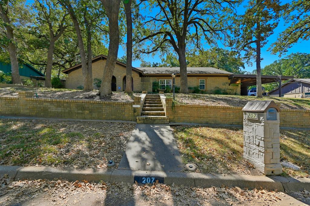 Welcome to Trailwood Addition in North Euless! No Hoa. 
Located just moments from Bob Eden Park and the scenic trail system, this home offers both convenience and charm. Step inside to a spacious open living area featuring vaulted ceilings with exposed beams and a beautiful fireplace — the perfect focal point for gatherings. The kitchen flows seamlessly into the living space, creating an inviting atmosphere for entertaining or everyday living.
This 4-bedroom home features a split floor plan for added privacy. Enjoy the oversized enclosed sunroom that provides endless possibilities — a second living area, playroom, or hobby space. Outside, you’ll find a large fenced backyard with an expansive patio deck built over a former pool, ideal for outdoor dining, storage, or even the opportunity to restore the pool. Additional storage buildings and covered carport parking complement the attached garage.
Refrigerator in the kitchen stays. Fantastic location, flexible spaces, and so much potential — come make this North Euless gem your own!