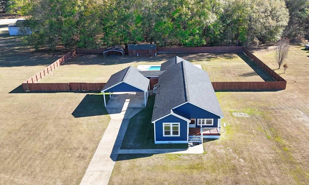 Welcome to 281 Virginia Circle—a place where space, sunshine, and easy living come together just outside the city. Sitting on nearly 3 acres, this home gives you room to breathe while keeping you perfectly connected: only 10 minutes to downtown Thomasville, 10 minutes to downtown Cairo, and just 30 minutes to Tallahassee, Florida. It's the kind of location that feels tucked away, yet incredibly convenient.  If outdoor living is your style, this home is a dream come true. Imagine summer days spent floating in the in-ground pool, soaking up the sun on the 24x20 open deck, and winding down in the evenings on the screened-in covered porch with a hot tub—your own private retreat for relaxing or entertaining friends and family. The pool is surrounded by Coolcrete, making barefoot days comfortable and carefree.  Inside, the home offers a warm, inviting layout with three spacious bedrooms, a comfortable living room anchored by a fireplace, and a large eat-in kitchen designed for gathering. The kitchen features a generous center island and glass display cabinetry—perfect for showcasing your favorite dishes and hosting casual meals or holiday get-togethers.  This property has been thoughtfully updated over the years, including a new roof in 2019, pool liner replaced in 2020, new insulation and HVAC in 2022, floors replaced within the last year, and exterior paint completed two years ago. The deck, screening, and enclosure have all been rebuilt within the last five years, giving peace of mind along with great style.  Outside, the wide-open yard offers endless possibilities—space for kids, pets, gardens, or simply enjoying the outdoors. Storage is no problem with a 12x28 storage building ready for tools, toys, or hobbies.  This is more than a house—it's a lifestyle of relaxation, entertaining, and country-style living with city convenience. Come see 281 Virginia Circle for yourself and fall in love with the way life feels here.