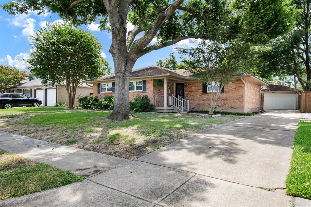 Welcome to 619 Stardust Lane, a beautifully updated 3-bedroom, 2-bath home in the heart of Richardson, zoned to Richardson Heights Elementary, West Junior High, and Richardson High School. Thoughtfully renovated with clean timeless choices and exceptional functionality, this move-in-ready home blends comfort, style, and everyday convenience, especially if you enjoy being active.  This home sits down the street from Heights Park, where you will find tennis courts, a fun playground, walking paths and a public swimming pool.  Next to the park is the Heights Recreation Center, which is a local fave for working out, playing basketball, and many other sports and activities. A metal front door with glass panels fills the entry with natural light and opens to an inviting, open-concept living, dining, and kitchen space. The remodeled kitchen is well designed for everyday life and entertaining with stainless appliances, a gas cooktop, new vent hood, and a French-door refrigerator. Custom cabinetry offers abundant storage with pullout shelves and deep drawers.Hardwood flooring is throughout the main living areas and in bedrooms. Living room is light and bright and anchored by a wood-burning fireplace with a gas starter. The primary bedroom has an oversized walk-in closet and an updated ensuite bath. The secondary bath is equally well-appointed with a soaking tub shower combination and storage. French doors with built-in blinds open to an large recently added patio creating great outdoor living and entertaining space. The big backyard offers plenty of  green space for pets, play, gardening, or future expansion. The oversized detached two-car garage offers extra storage, with a new manual iron gate coming soon.Many major system updates have already been completed, including new windows 2020, HVAC 2019, and water heater 2018, providing added peace of mind. Fresh interior paint completes this meticulously maintained home, making it truly move-in ready.