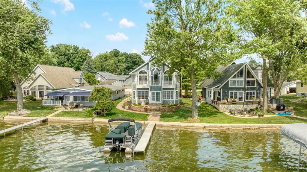 Located on the highly sought-after Cherry Point, this custom-built, one-owner home offers 50 feet of pristine frontage on all-sports Devils Lake!  With 4 spacious bedrooms and 3 full bathrooms, this thoughtfully designed home features two living rooms, perfect for entertaining or hosting extended family and friends. The gas fireplace adds warmth and charm to the second-level living area, while the second-level laundry adds everyday convenience.  Upstairs, the primary suite includes a private balcony overlooking the water ideal for quiet mornings or sunset views. The attached 2.5-car garage provides ample space for vehicles, lake gear, and storage.  Whether you're looking for year-round lake living or a summer getaway, this home combines quality construction, generous space, and one of the best locations Devils Lake has to offer.