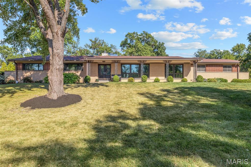Step into this stunning mid-century modern home featuring 4 bedrooms, 3 full baths, and approximately 4,200 total square feet. Architectural character and thoughtful modern updates come together beautifully throughout the property. The well-designed layout seamlessly connects the spacious kitchen with the open, light-filled impressive family room featuring 11 ft vaulted beam ceilings framed by dramatic floor-to-ceiling windows, bringing the outdoors in and filling the space with natural light. Newly refinished hardwood floors and all-new light fixtures add a fresh, modern touch while complementing the home’s original character. The spacious primary suite offers a private retreat with a walk-in closet, while main-floor laundry provides everyday convenience. The lower level expands the living space, with a versatile bedroom and full bath, along with a well-equipped home gym-ideal for guests, a home office, fitness, or additional living needs.Outside, enjoy exceptional outdoor living on approximately 0.7 acres, featuring a beautiful, level backyard with ample room to relax, entertain, and enjoy the surrounding space. This special home reflects the current owners’ thoughtful transformation, perfectly balancing mid-century design, architectural character, and today’s modern lifestyle.