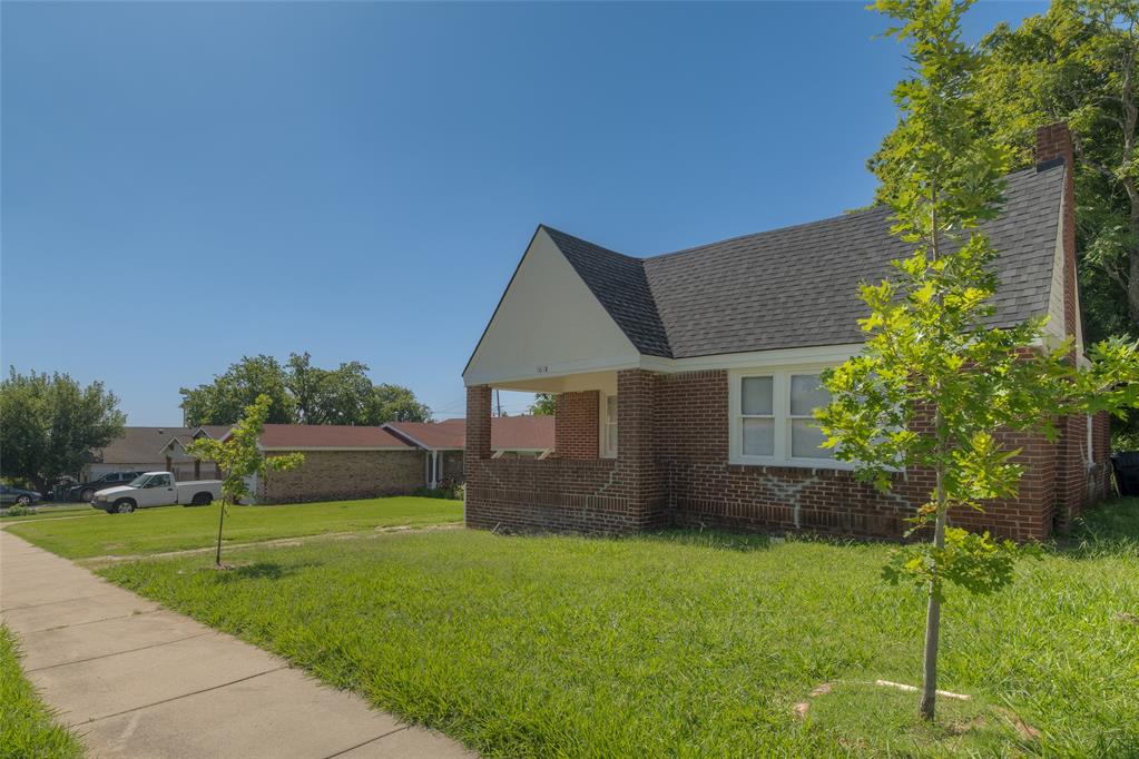 Charming brick Tudor at 1618 with 2 bedrooms and 1 bath, full of original character. Arched doorways lead into a light-filled living room anchored by a brick fireplace flanked by built-in bookshelves, all set against gleaming hardwood floors and original wood-trimmed windows throughout. The kitchen retains its vintage charm with butcher block counters, a tiled backsplash, and abundant cabinet storage. Major systems have been thoughtfully updated: HVAC (2020, serviced biannually), electrical riser (2020), water heater (2022), roof (2025), and foundation work completed in 2019 with a transferable lifetime warranty.