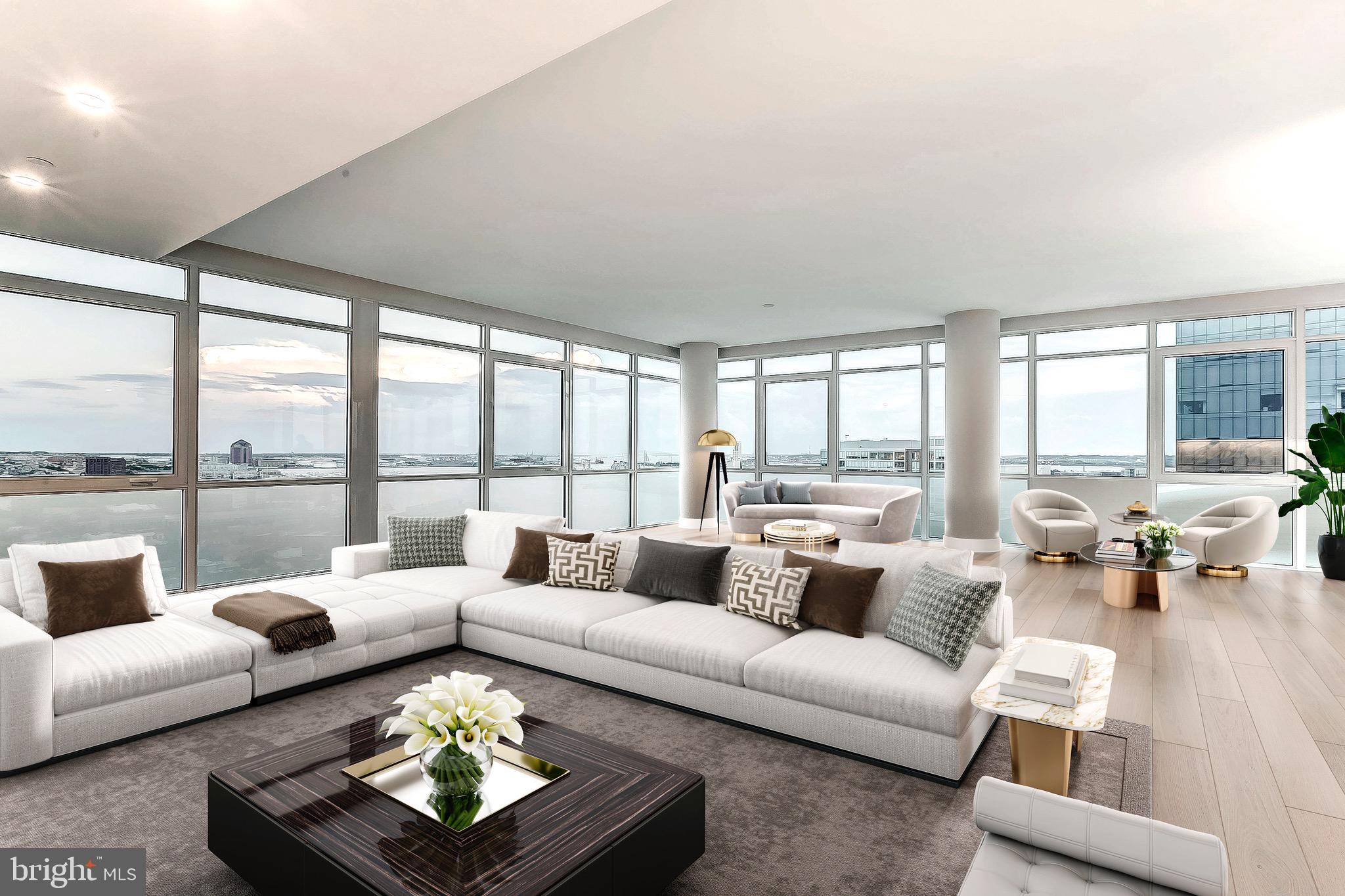 Rare opportunity to own a spectacular, one-of-a-kind, full floor Penthouse duplex in the heart of Harbor East.  Boasting over 5,000 square feet of interior living, this stunning 2-story, 4 bedroom with loft, 3.5 bath has sweeping views of the Patapsco River, the downtown skyline and Baltimore's Inner Harbor from nearly every room. The private elevator foyer opens into a breathtaking full floor residence showcasing an open-concept living room, dining room, and kitchen, airy 10-ft ceilings, designer light fixtures, solid white oak hardwood and private balcony. The custom designed Chefs kitchen features an oversized eat in marble waterfall island with seating for 5 and is appointed with Italkraft cabinetry, professional-grade Thermador appliances including a 6 burner gas range with vented wall hood and a microdrawer microwave. The luminous primary bedroom suite is a sanctuary with open southern water views, a generous walk-in closet and luxurious marble en-suite master bath with custom dual vanity and walk-in shower. The main level of the residence also houses 2 additional guest bedrooms, full bath and laundry room.  A floating staircase draws you up to the second floor where there is a secondary master suite, powder room, and expansive loft with floor to ceiling windows, gas fireplace and Wet bar that leads to the expansive 1,000 square foot private terrace creating the ideal environment for indoor / outdoor living. 2 dedicated parking spaces convey with this offering. New construction 5 year tax phase-in applies. Liberty Harbor East is Baltimore's newest luxury waterfront address. The boutique condominium offering 33 residences with stunning waterfront architecture, designer finishes, and an enviable Harbor East location atop a brand new flagship Whole Foods Market create the opportunity for the ultimate downtown lifestyle. Liberty is located in the heart of Harbor East surrounded by best-in-class dining, shopping and conveniences of downtown living. Residents will enjoy a private Concierge level with social lounge, automated and secured package room and ButterflyMX intercom security system. Residents will also enjoy access to over 30,000 square feet of private, state-of-the-art indoor and outdoor amenity spaces including a clubroom with indoor/outdoor bar, rooftop infinity pool deck with cabanas, courtyard seating, grilling stations, communal and private dining rooms with catering kitchen, fitness center, yoga studio, Pet park with dog agility and training equipment, conference rooms, study lounge with computer stations and fireplace.