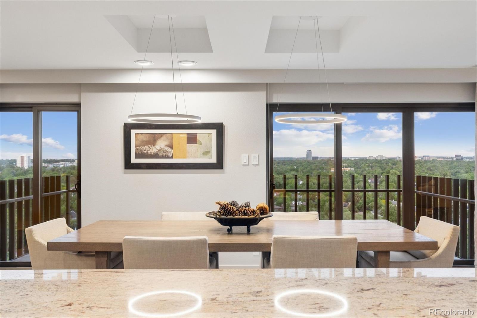 A private sanctuary 18 floors above Washington Park, this residence offers more than 3,300 square feet of refined living with sweeping, unobstructed views across the treetops, lake, mountains, and Denver skyline. Inside, warm, luxurious finishes include designer lighting, wide-plank hardwood floors, plush wool carpeting, and custom linen drapery with solar shades, each detail selected to evoke quiet sophistication. The expansive floor plan unfolds with a beautifully appointed kitchen featuring a Sub-Zero refrigerator, wine fridge, Viking microwave and oven, warming drawer, cooktop, and stainless steel hood. The space offers abundant cabinet storage with pull-out drawers, generous prep space, a walk-in pantry and a charming eat-in nook with mountain views. The dining area opens to a balcony with views of the park and lake, while the living room, study, and separate office offer elegant versatility. The full laundry room—complete with a utility sink, refrigerator, and ample cabinetry—blends form and function. The primary suite is a serene retreat, complete with a wall of cedar-lined closets, separate walk-in closet, spa-style bath, and access to its own balcony. A second bedroom, thoughtfully placed on the opposite side of the home, offers privacy and its own balcony with mountain views. Two storage units are also included.Residents at Park Lane enjoy an exceptional suite of amenities: indoor and outdoor pools, spa/hot tub, fitness center, library, entertainment lounge with kitchen, game room with billiards and ping pong, guest suites, and 24-hour concierge and security.Located directly across from iconic Washington Park with its winding trails, formal gardens, tennis courts, lakes, and recreation center and just minutes from neighborhood favorites like Devil’s Food Bakery, Max’s Gill & Grill, The Green Collective and Perdida Mexican Cuisine. Easy access to Cherry Creek’s premier shopping, dining, and bike paths completes this elevated Denver lifestyle.