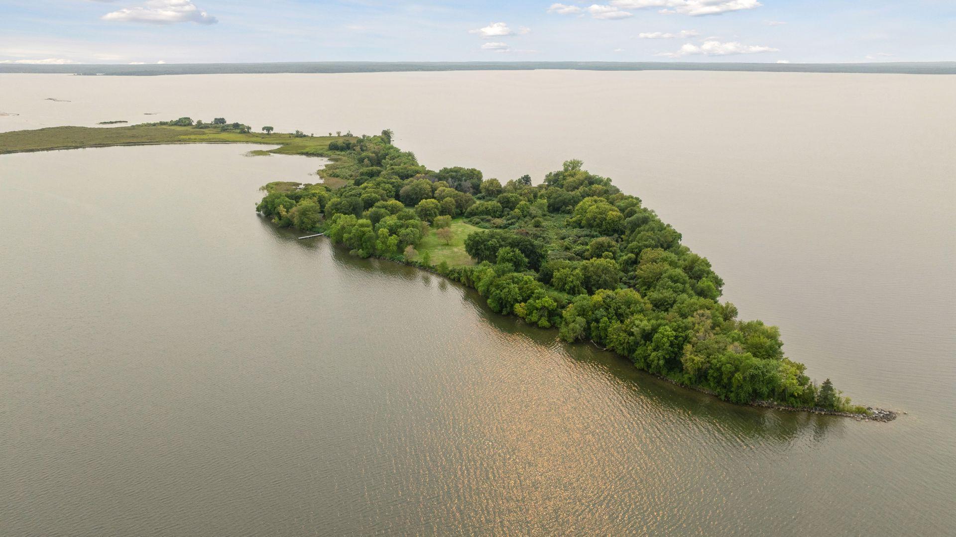 Have you ever dreamed of owning property on an island? Here’s your chance to make that dream come true. Nestled on Leech Lake, this one-of-a-kind retreat offers a perfect blend of rustic charm, serene natural beauty, and unforgettable experiences. Just a 15-minute boat ride delivers you to your own peaceful haven, where the everyday world fades away. With approximately 35 acres of privacy surrounded by sparkling water, this rare property is the perfect backdrop for long weekends, reunions, lake “Olympics,” or simply quiet sunsets and starry nights by the bonfire. And if you’re in the mood for some excitement, there are various lodges around the lake — accessible by boat — where you can enjoy dining, shopping, and entertainment to round out your stay. The property offers your own island playground — perfect for gatherings big or small — with a main house and three cozy cabins that sleep 13 comfortably (plus room for two more if you don’t mind roughing it!) You’ll enjoy two beaches, including a sandy one ideal for swimming and sunbathing, endless space for lawn games, volleyball, exploring, and adventure, and scenic trails through lush, jungle-like woods. Golf carts, a Bobcat, and a vintage tractor let you get around in style, while kayaks and a rowboat invite you to explore the shoreline — about an hour to paddle all the way around. Fully furnished and ready to enjoy, all you need to bring are your swimsuits and s’mores. At the end of the day, gather around the lakeside bonfire under a sky full of stars — the perfect way to wrap up a day of swimming, paddling, fishing, and memory-making. While another owner holds a portion of the island, it’s naturally separated by marsh and harbor, preserving your privacy. If you’re looking for something truly extraordinary — a place to laugh, play, and connect — this private island retreat is waiting for you. It is being sold as is. The listing agent is also the owner.