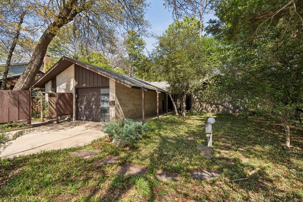 Tucked away at the quiet end of Hollywood Avenue where it gently curves into Hollywood Circle, this one-of-a-kind midcentury modern retreat offers rare privacy and timeless design. This architectural gem was custom designed and built by James Henkle, a University of Oklahoma faculty member and accomplished fine art furniture maker whose work is preserved in the Smithsonian archives.This home is a true work of art, with all original cabinetry handcrafted by Henkle himself, showcasing his exceptional craftsmanship and attention to detail. In the dining room, a built-in display case across from the French pellet stove highlights several of his furniture models discovered during the home's restoration. Floor-to-ceiling windows invite the outdoors in, while flagstone floors add warmth and texture, enhancing the home's organic connection to its natural setting. Situated on a wooded lot backing to the creek and greenbelt, the property offers unmatched tranquility and a sense of peaceful seclusion. Lovingly preserved, this home retains its original character while offering a rare opportunity to own a piece of functional art. Two storage sheds provide additional space, including one outfitted with the original exhaust fan used during Henkle’s woodworking days. With minimal traffic and a setting that feels worlds away, this special property is a sanctuary for those seeking beauty, history, and harmony with nature. Ask your Realtor for a copy of the article published in Oil and Wood (included with the disclosures), to get more details and color photos of Henkle’s art as featured in an exhibition at the Fred Jones Jr. Museum of Art.  Home is being sold AS-IS and Seller requests closing to be after Memorial Day. Don't let this one get away!