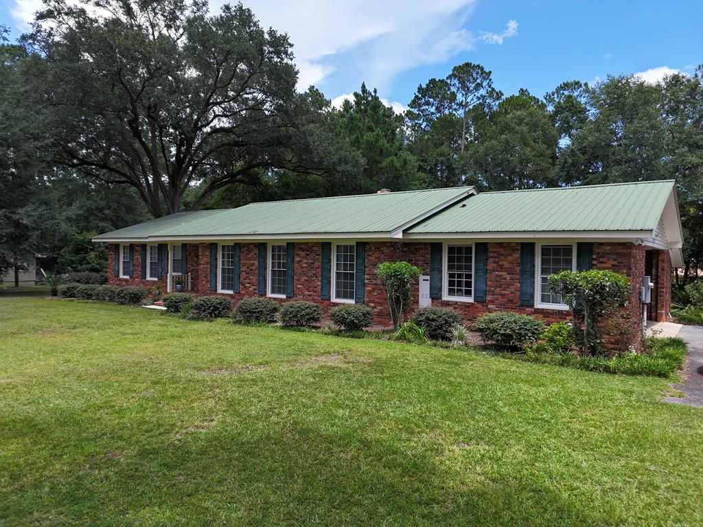 Charming, 3 bedroom/2 full baths brick ranch-style home with open, spacious rooms; many with original hardwood flooring. Bright and airy layout, et with sufficient privacy. Kitchen has stainless steel appliances; beautiful patio for outdoor entertaining and storage area. This home also has a double garage and is beautifully maintained. 1,920 sq. ft on 0.91 acres with paved driveway. Showing by appointment only with 24-hour notice.