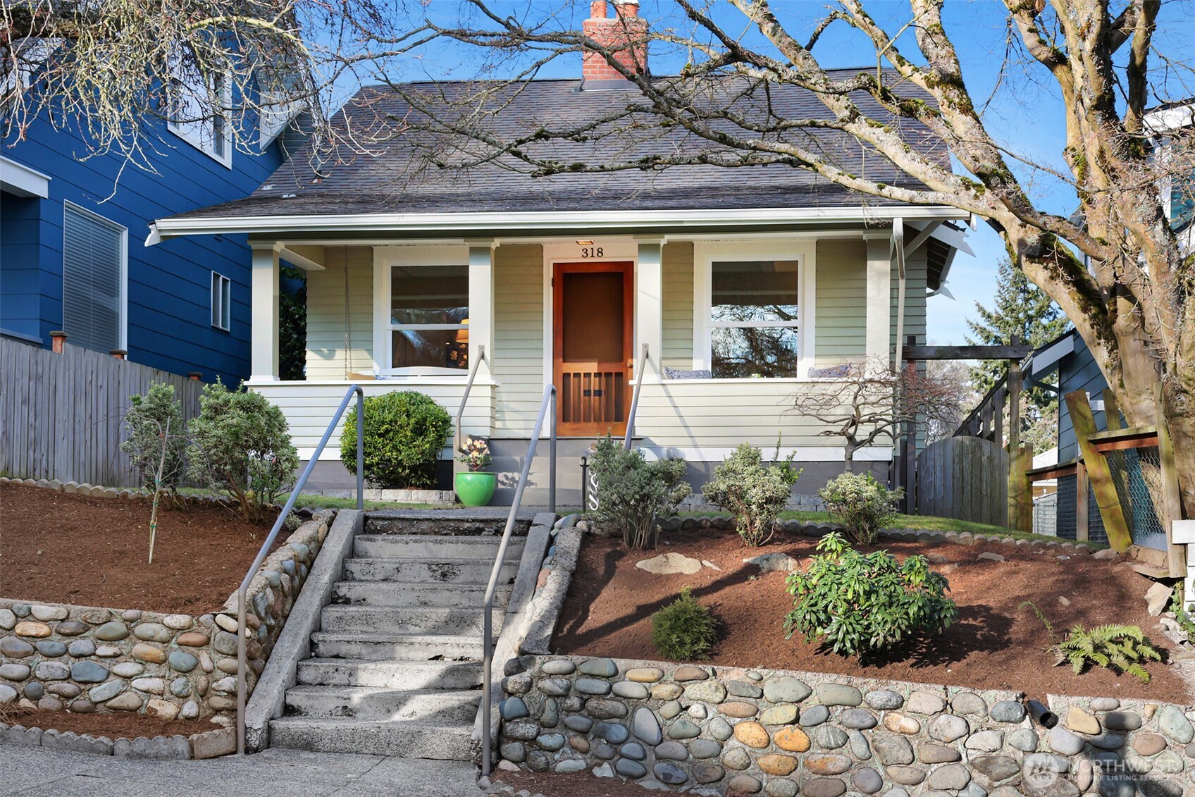 Adorable Phinney Ridge Craftsman with picturesque, rocking chair front porch. Perfectly located near all the fun and amenities that Phinney Ridge & Greenwood have to offer. South facing home with abundant natural light and charming as they come! Refinished hardwood floors, updated kitchen with quartz counters, fresh paint throughout and move in ready. Newer furnace & air conditioning, good storage in the partially finished basement with good potential to add living space in the future. Driveway behind home with alley access for parking. A few blocks down the hill to Green Lake for all the summer fun! Easy commuter location to South Lake Union or Downtown.