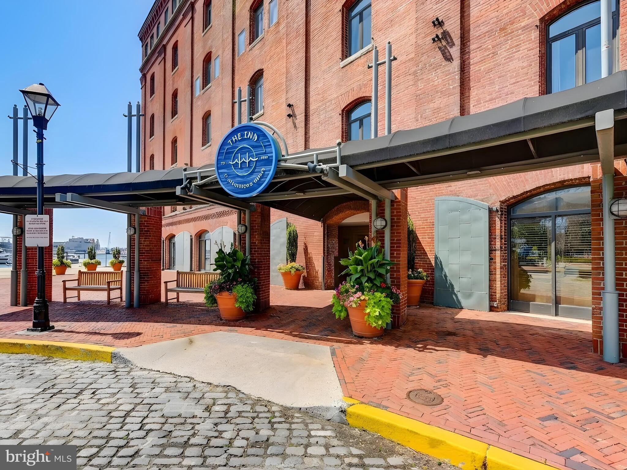 Experience waterfront living in the heart of historic Fells Point in this beautifully updated one-bedroom condominium with stunning harbor and city views. This light-filled residence offers an open floor plan featuring exposed brick walls, hardwood floors, and a spacious living and dining area perfect for entertaining. Enjoy relaxing water views from the living space and bedroom while taking in the charm of Baltimore’s iconic waterfront neighborhood.The gourmet kitchen is appointed with stainless steel appliances, granite countertops, and a convenient breakfast bar. Additional features include a wood-burning fireplace, updated bath, and in-unit laundry. The spacious bedroom suite provides a peaceful retreat with picturesque views and ample closet space. Located just steps from Fells Point’s renowned waterfront promenade, restaurants, shopping, and nightlife, this condominium offers the perfect blend of historic character and modern city living.