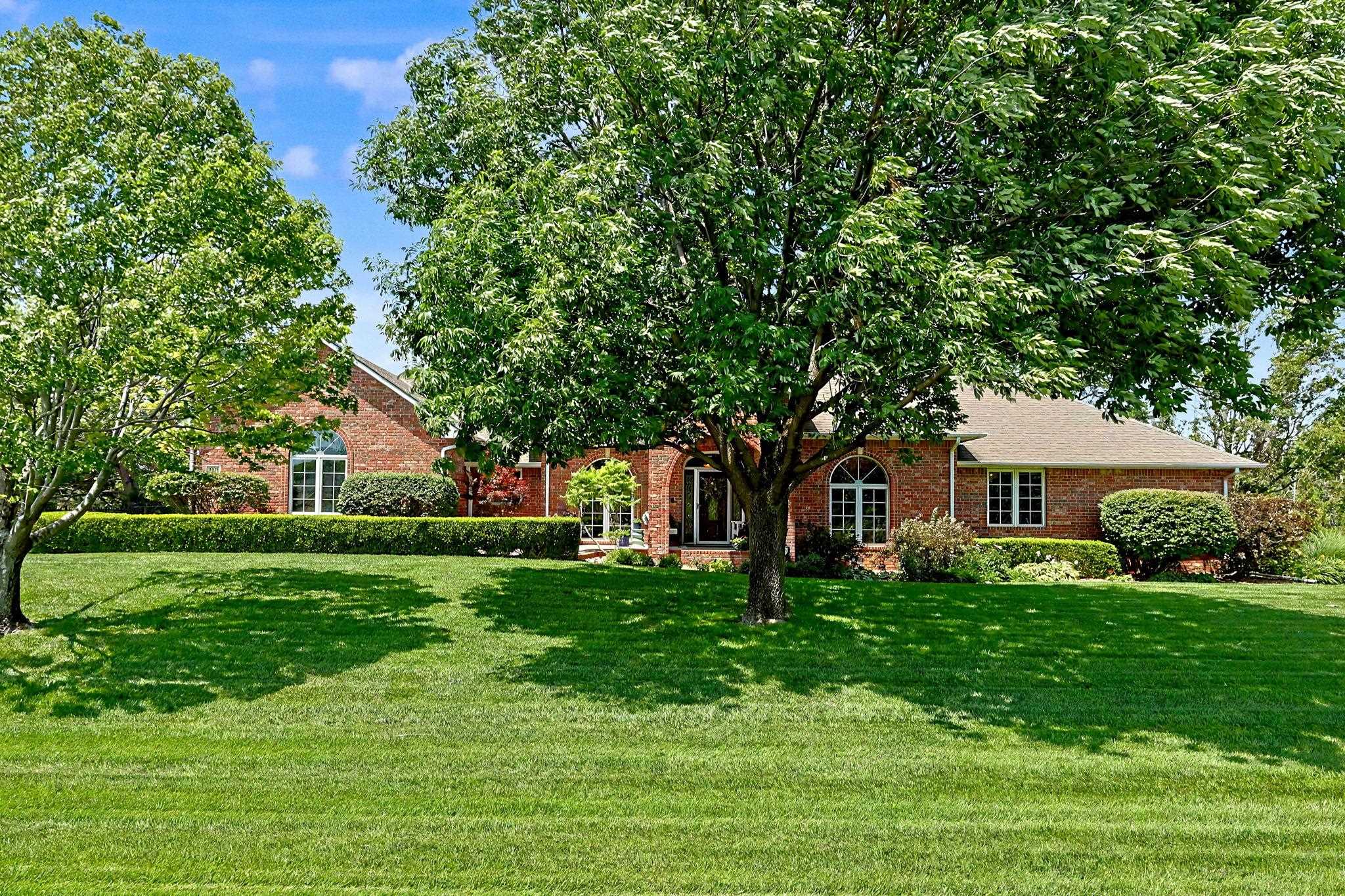 This beautiful one-owner, full brick ranch style home in the Savanna at Castle Rock Ranch neighborhood is located on more than ½ acre of land and features mature trees, fantastic landscaping and incredible backyard privacy. This home is designed for all phases of life with zero entry (no steps) at the front porch, the garage, the covered patio and the covered deck, plus an elevator to the lower level! 5 bedrooms, 4 full baths and over 4,700 SF finished. The 2,688 SF main floor includes 3 bedrooms, a beautifully updated kitchen, two dining areas and two living spaces. The updated walkout basement includes a large family room and game room area, 2 bedrooms, an exercise room and lots of storage space. With a neighboring 75-acre ranch behind the home and a 3-acre estate across the street, this property features both exquisite views and amazing privacy. Just a short a golf cart ride from Crestview Country Club, an easy walk to the Redbud Trail, a 5 minute drive to many of east Wichita’s premier dining and shopping destinations and less than 10 minutes to the best public and private school options in the area.