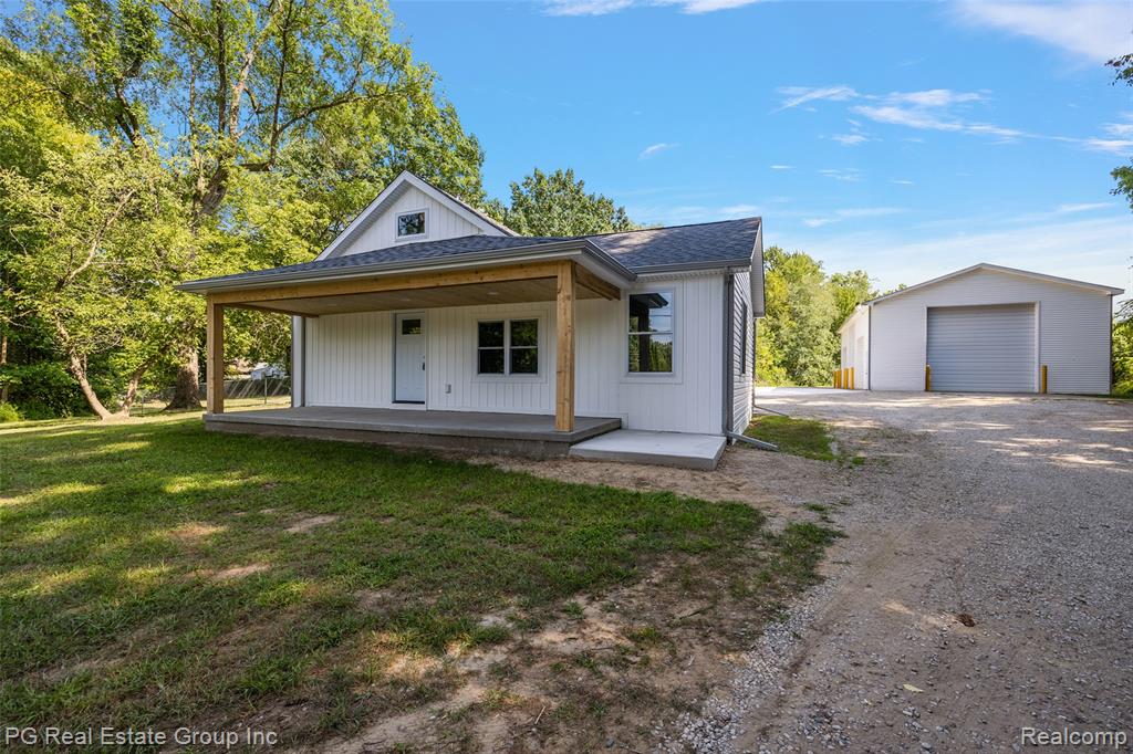 Rarely Available – Fully Renovated Bungalow on 10 Acres in St. Clair

Discover a perfect blend of modern luxury and country tranquility at 5771 Gratiot. Set on 10 wooded acres, this 4-bed, 2-bath home offers 1,600+ sq ft of open-concept living, completely renovated in 2025. A charming covered front porch welcomes you inside to rich hickory hardwood floors, LED lighting, and a spacious living room flowing into the dining area with outdoor access.

The chef’s kitchen boasts quartz countertops, full-height tile backsplash, modern cabinetry, and gas/electric hookups. The massive primary suite features a walk-in closet and spa-inspired bath with an oversized shower. Three additional large bedrooms share a stylish full bath with a tub/shower combo. The huge laundry room is ready for gas or electric appliances. Upstairs, a versatile bonus room awaits—perfect for an extra bedroom, lounge, or storage.

Enjoy a newly built 2&#189;-car attached garage plus a 52x20 pole barn with 15’ ceilings, 220 electric, LED lighting, and five insulated overhead doors. The fenced backyard includes a dog house and storage shed—ideal for pets and play.

Every detail is new: garage, roof, windows, AC, furnace, plumbing, electrical, hot water tank, septic tank & field, kitchen, baths, doors, and flooring. A fruit cellar (Michigan basement) adds character and storage.

This turn-key retreat offers unmatched privacy while being minutes from town—ready for your next chapter.